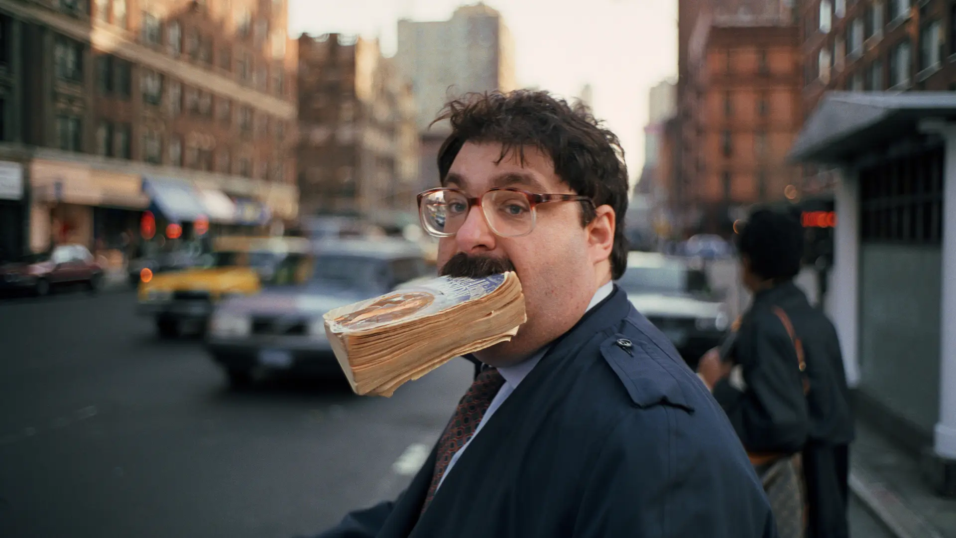 Man with a book in his mouth