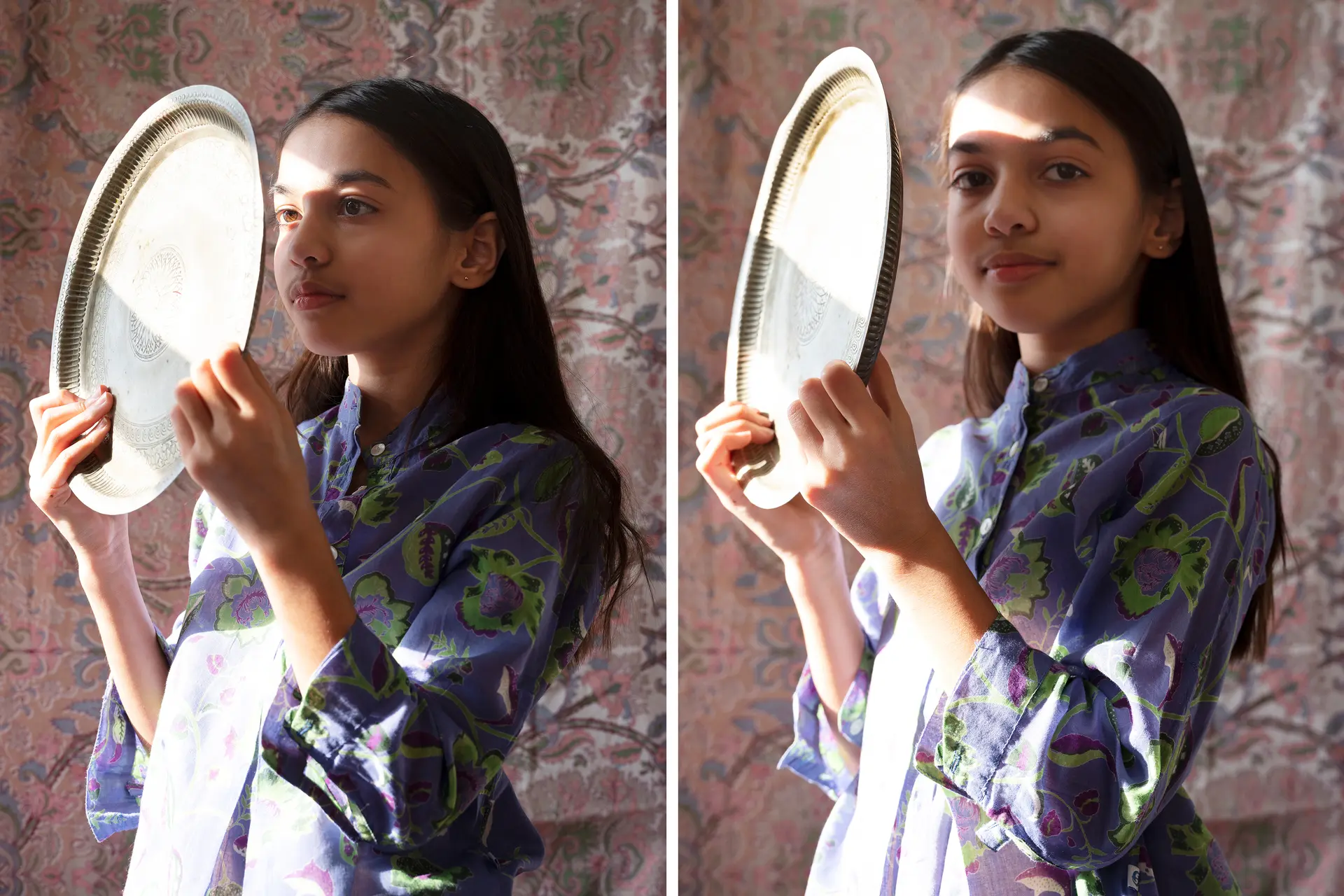 Young girl with long brown hair holding a large plate in front of her face