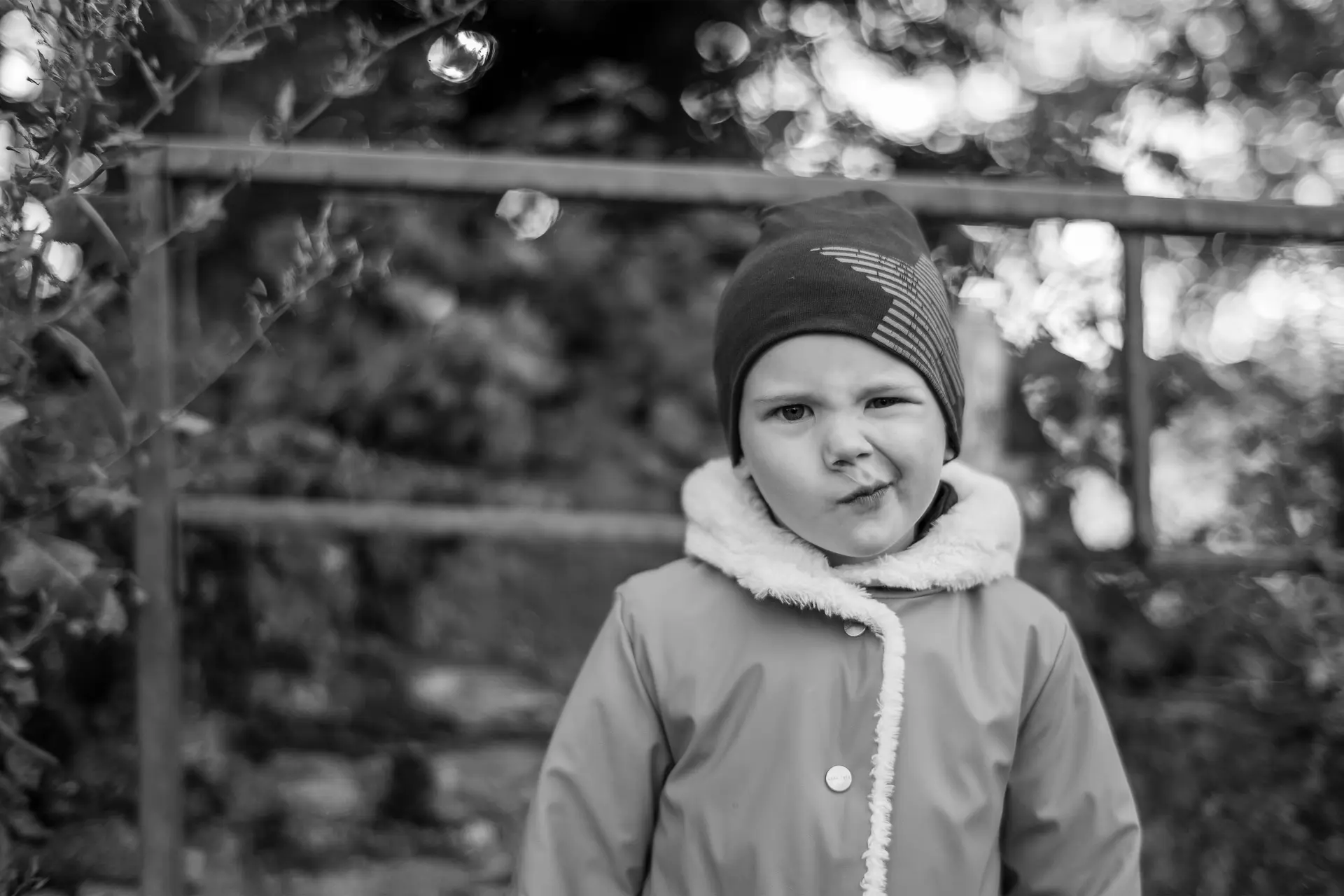 A young boy pulls a face.