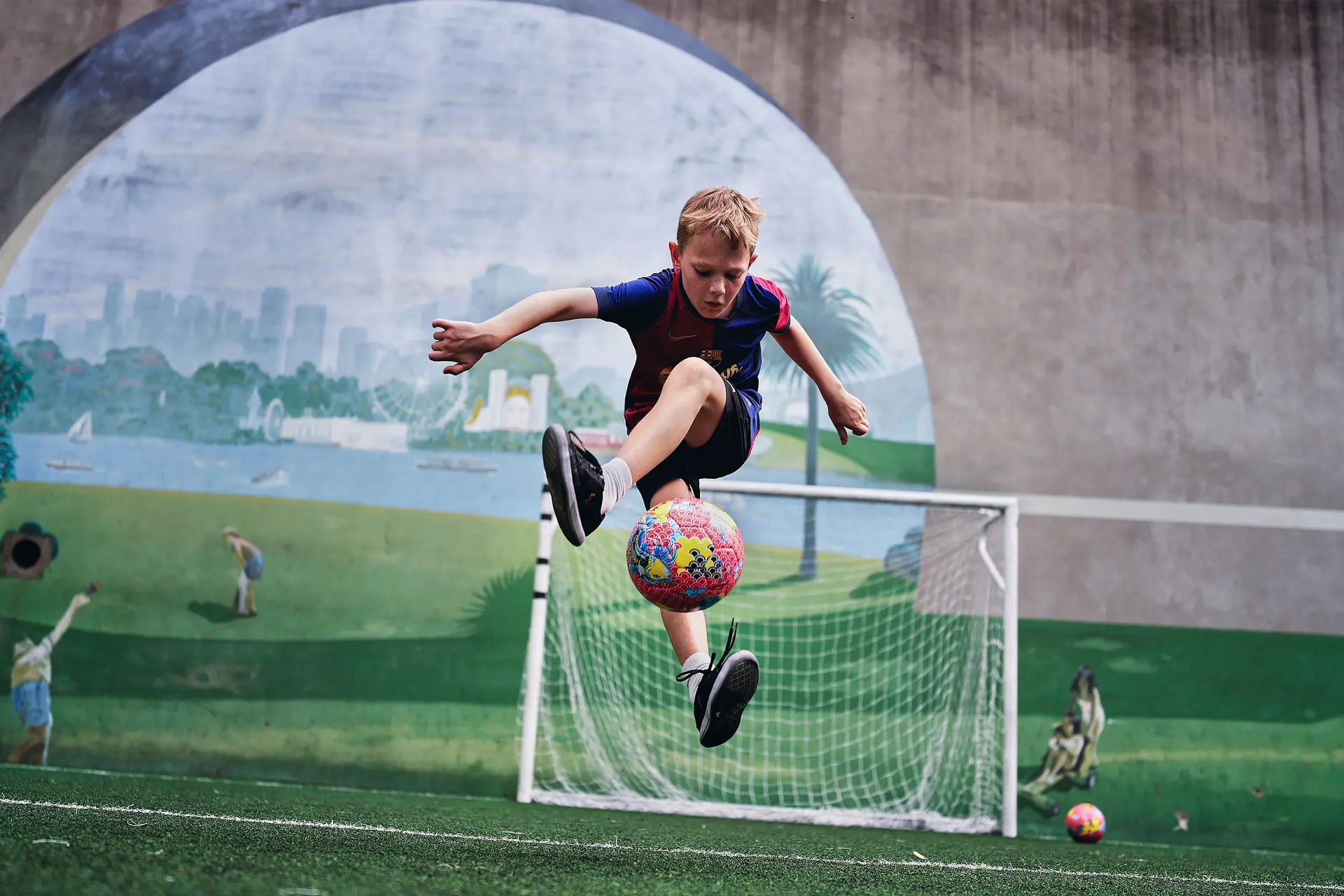 Boy jumps to catch football