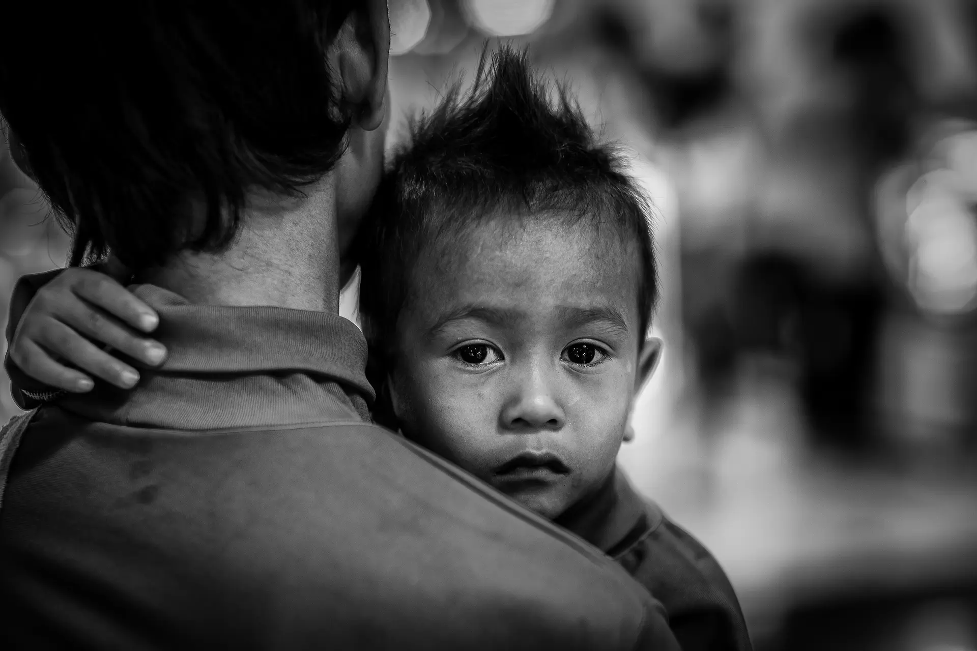 A little boy in the arms of a man