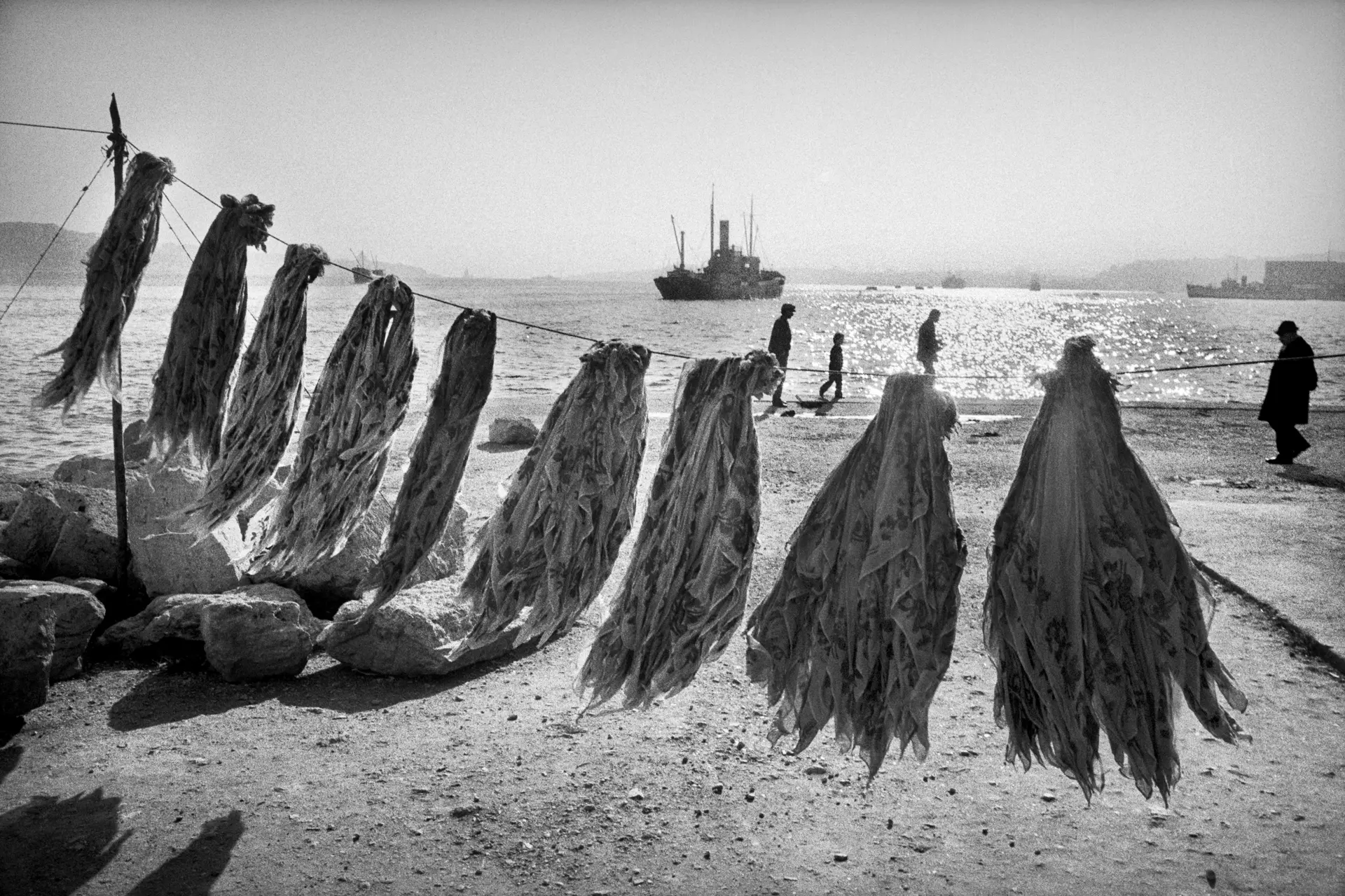 several cloths hanging on a line at the harbour