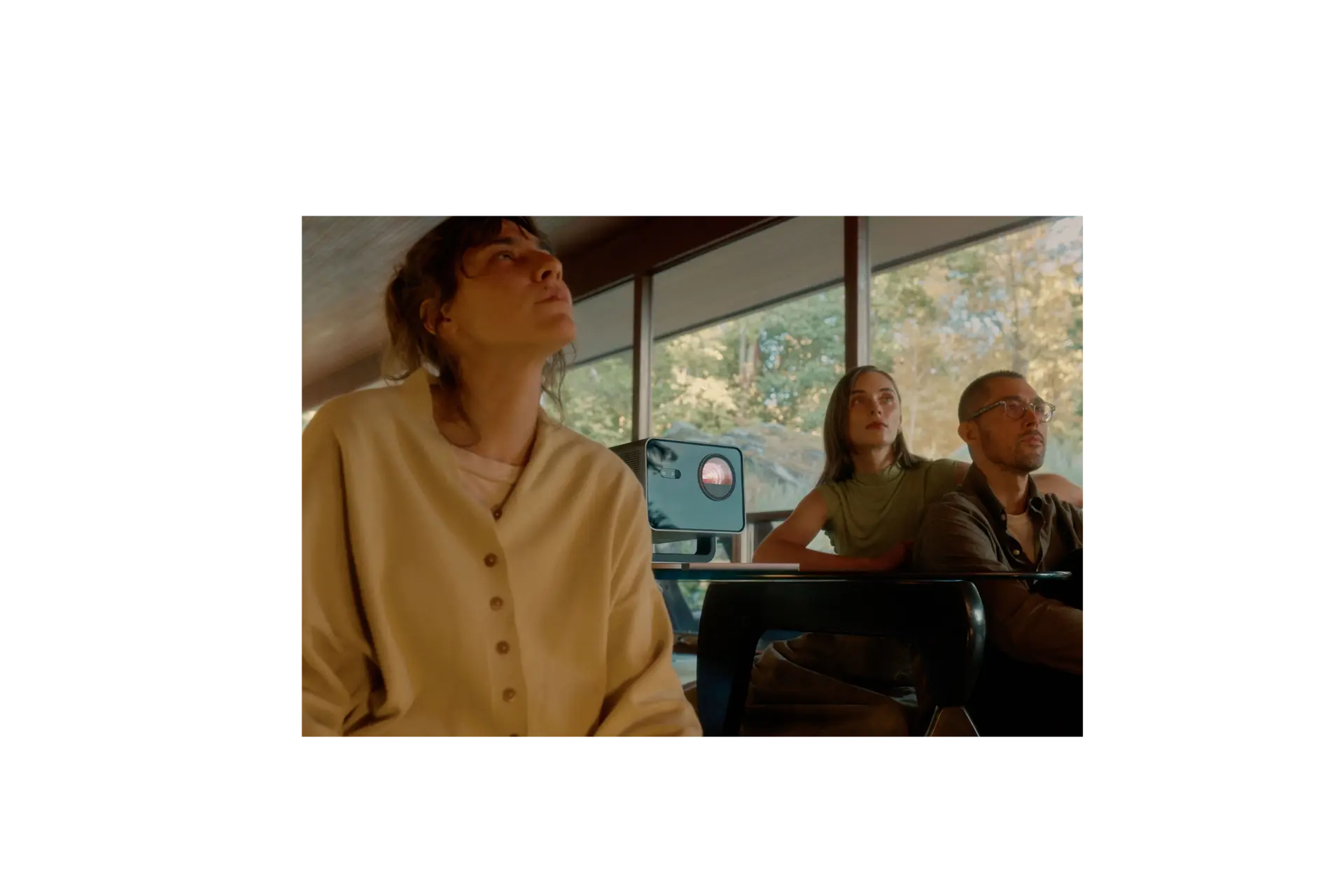 Three people watching a film with Cine Play 1