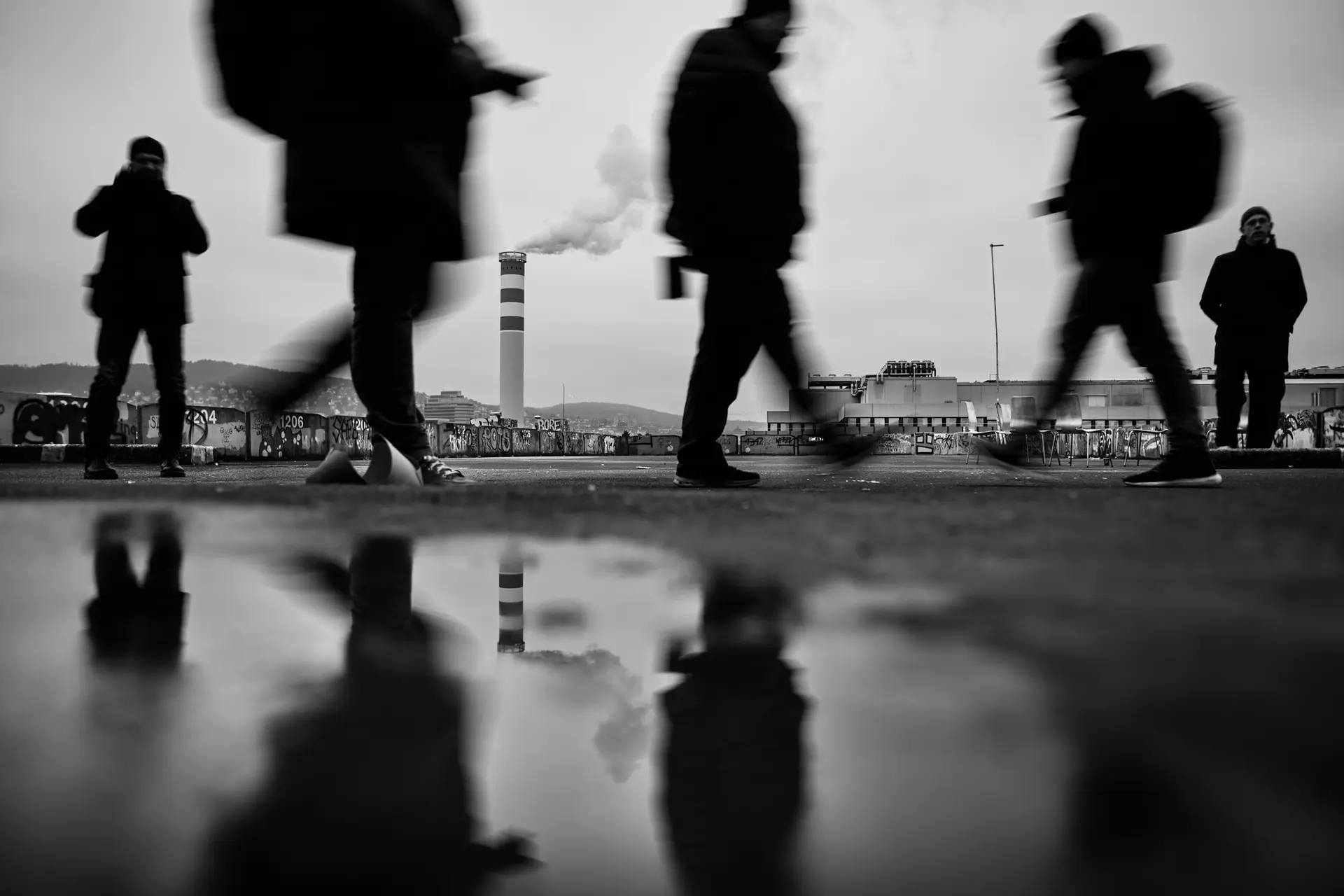 People walking through wet streets.