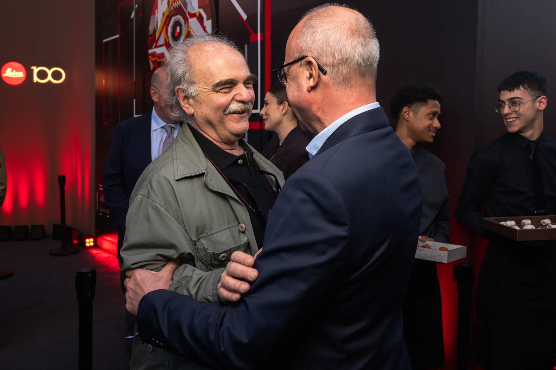 Guests laughing at the century event in Milan