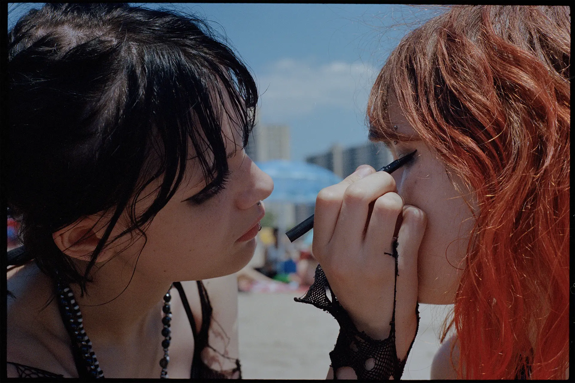 2 young girls doing each other's make-up