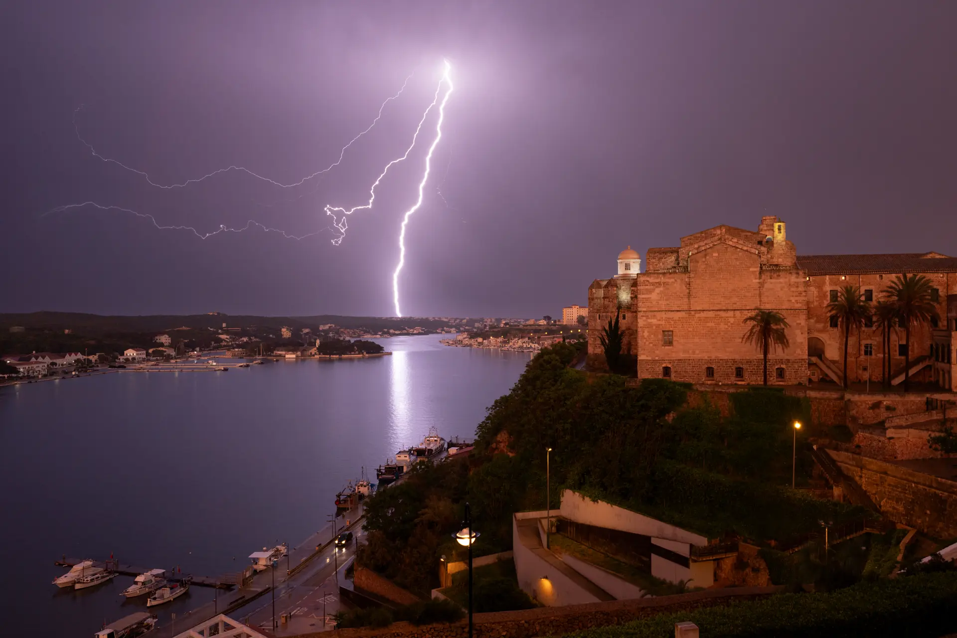 Lightning strikes in a town by the river