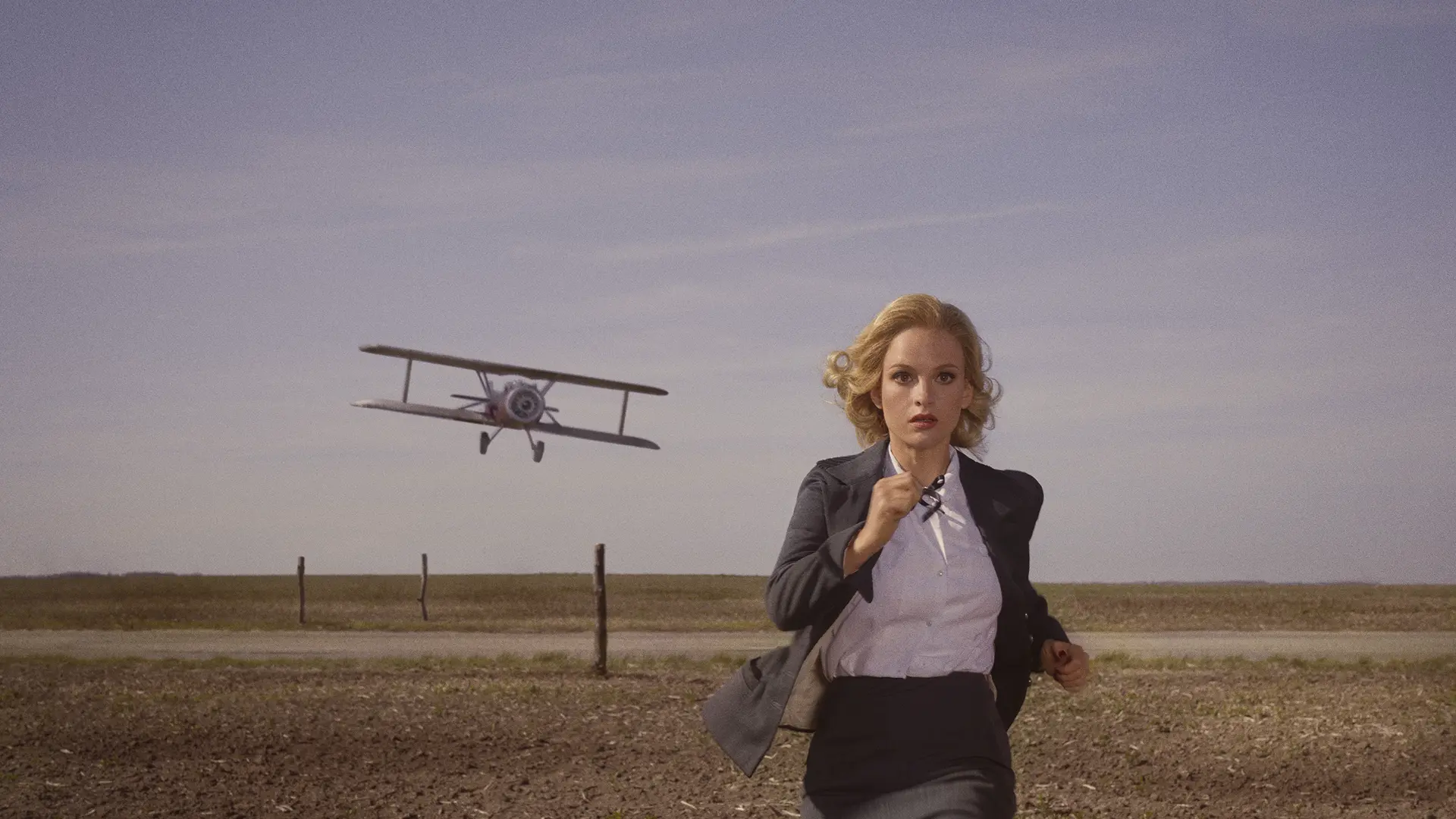 Woman is running. A glider flies low behind her