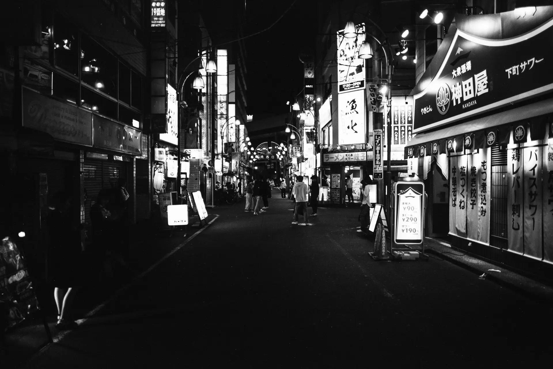 Street with restaurants and shops in a japanese town.