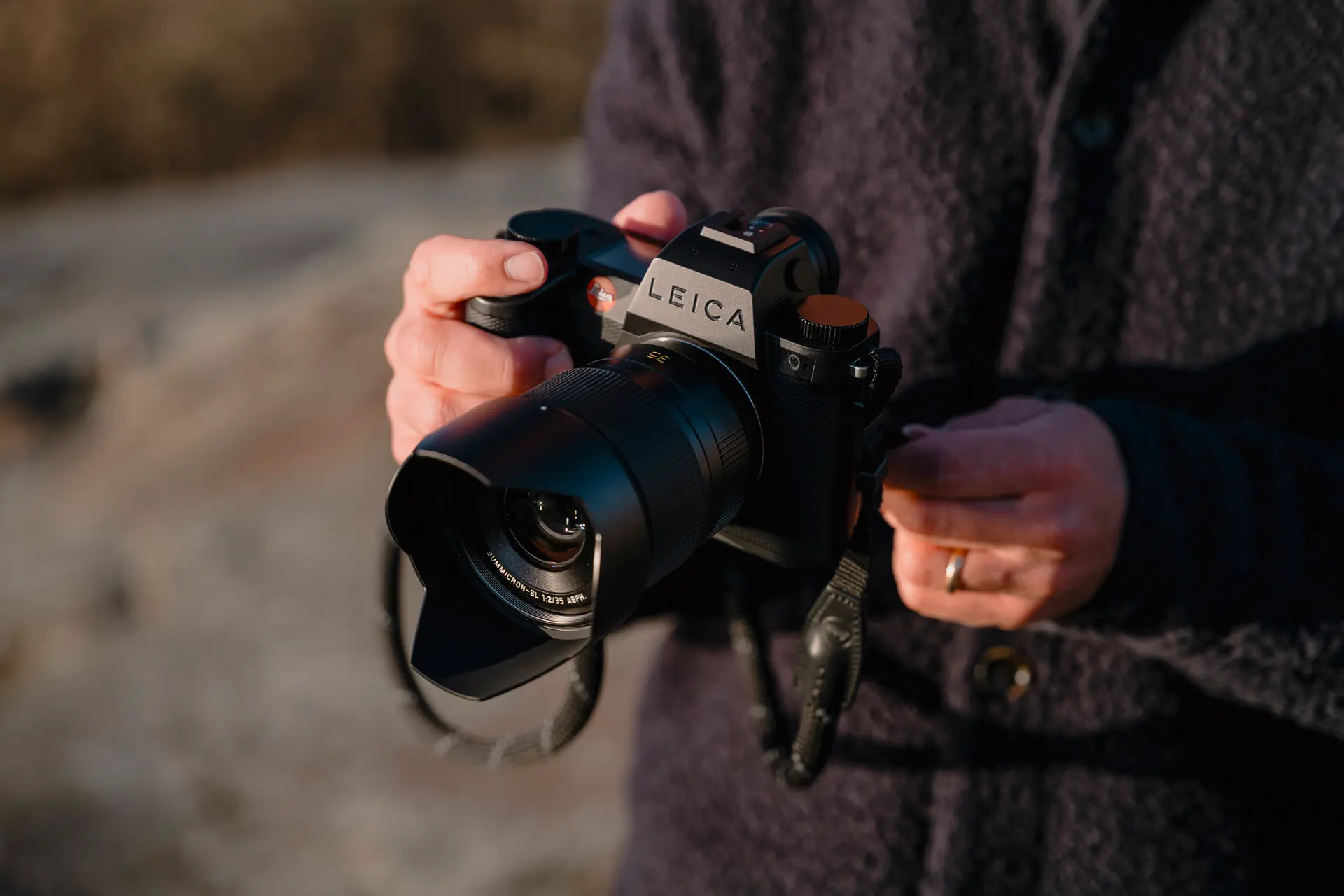 A person is holding the Leica SL3-S