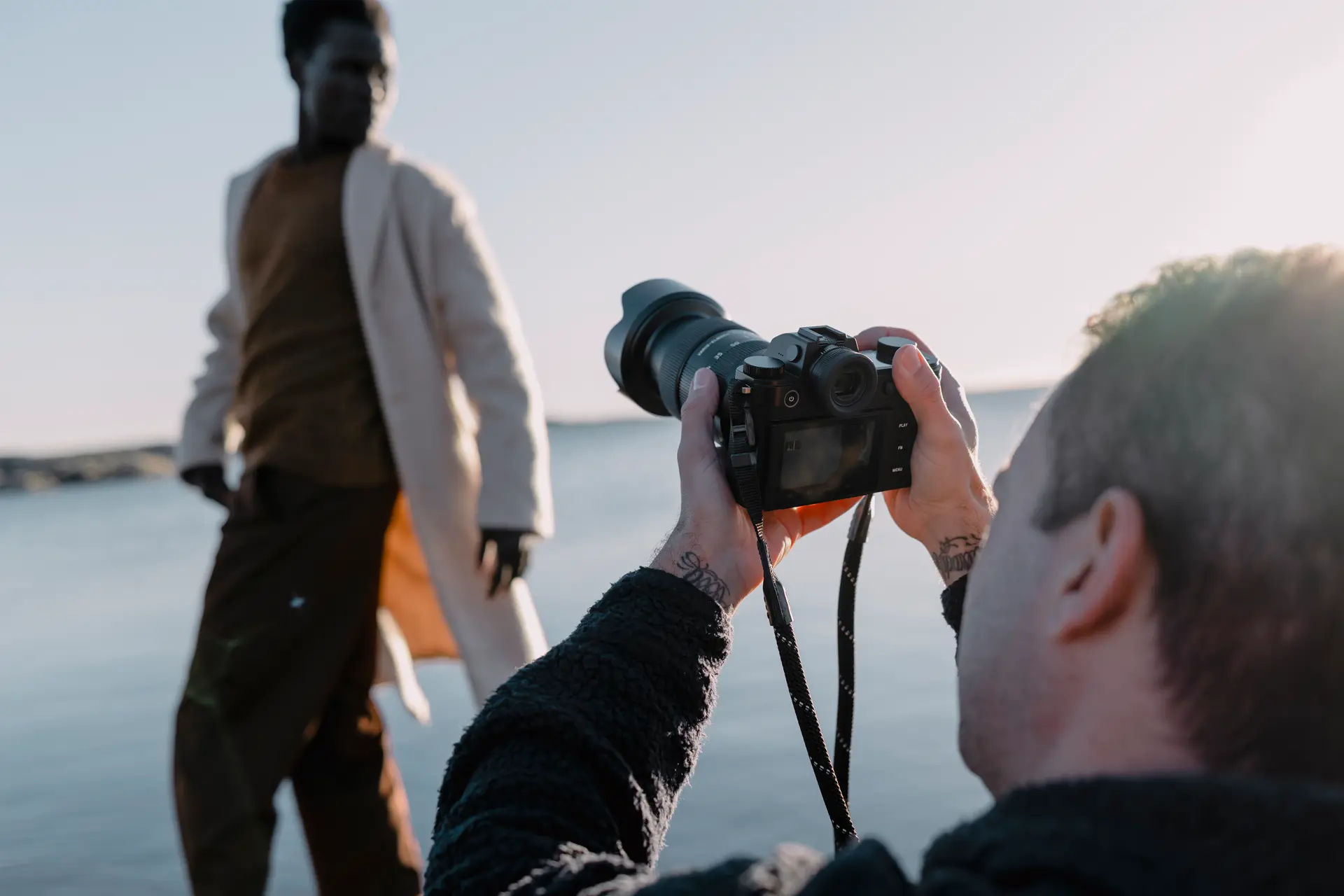 A person is taking photos of a model with the Leica SL3-S