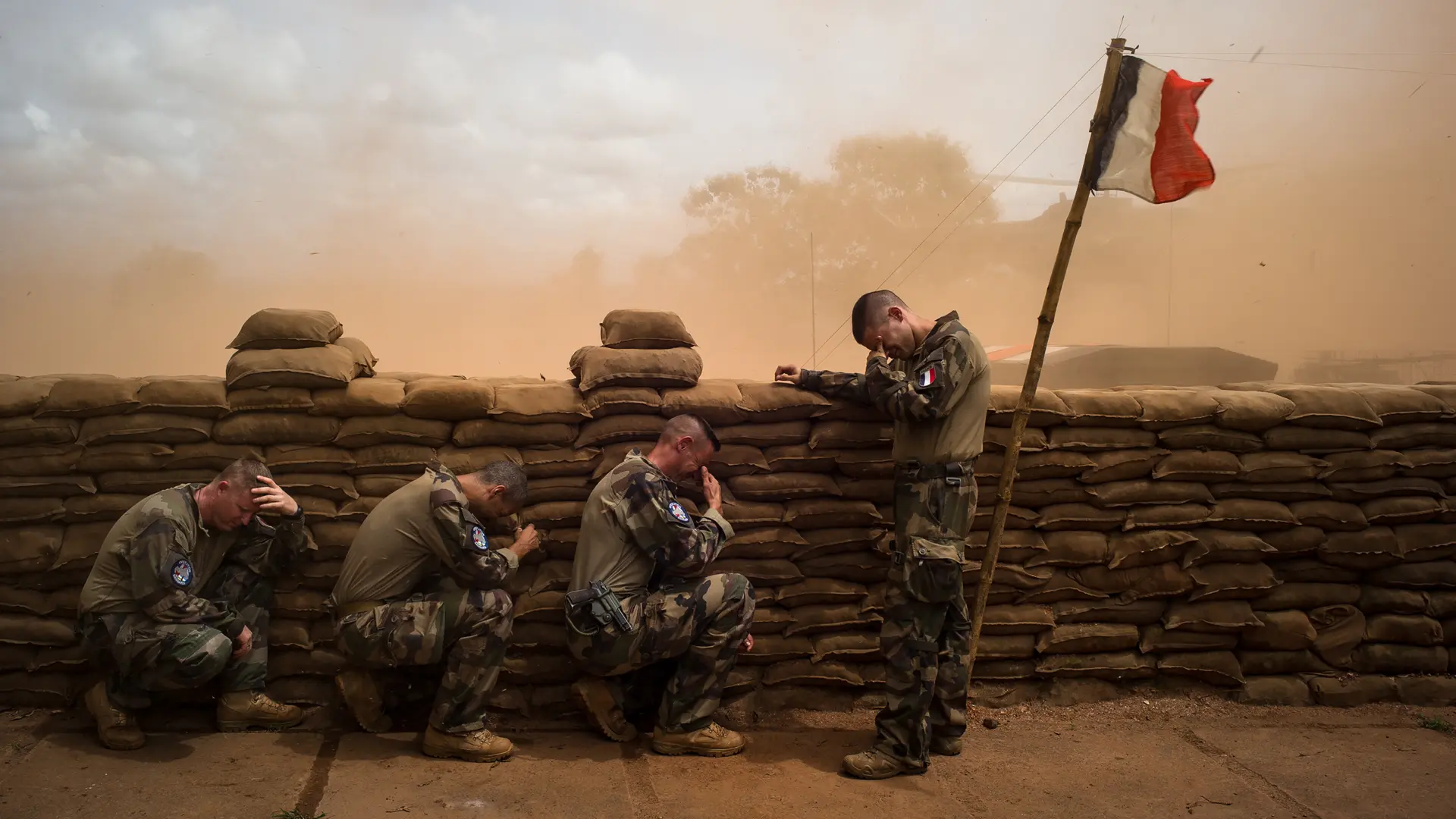 Weeping soldiers behind a wall