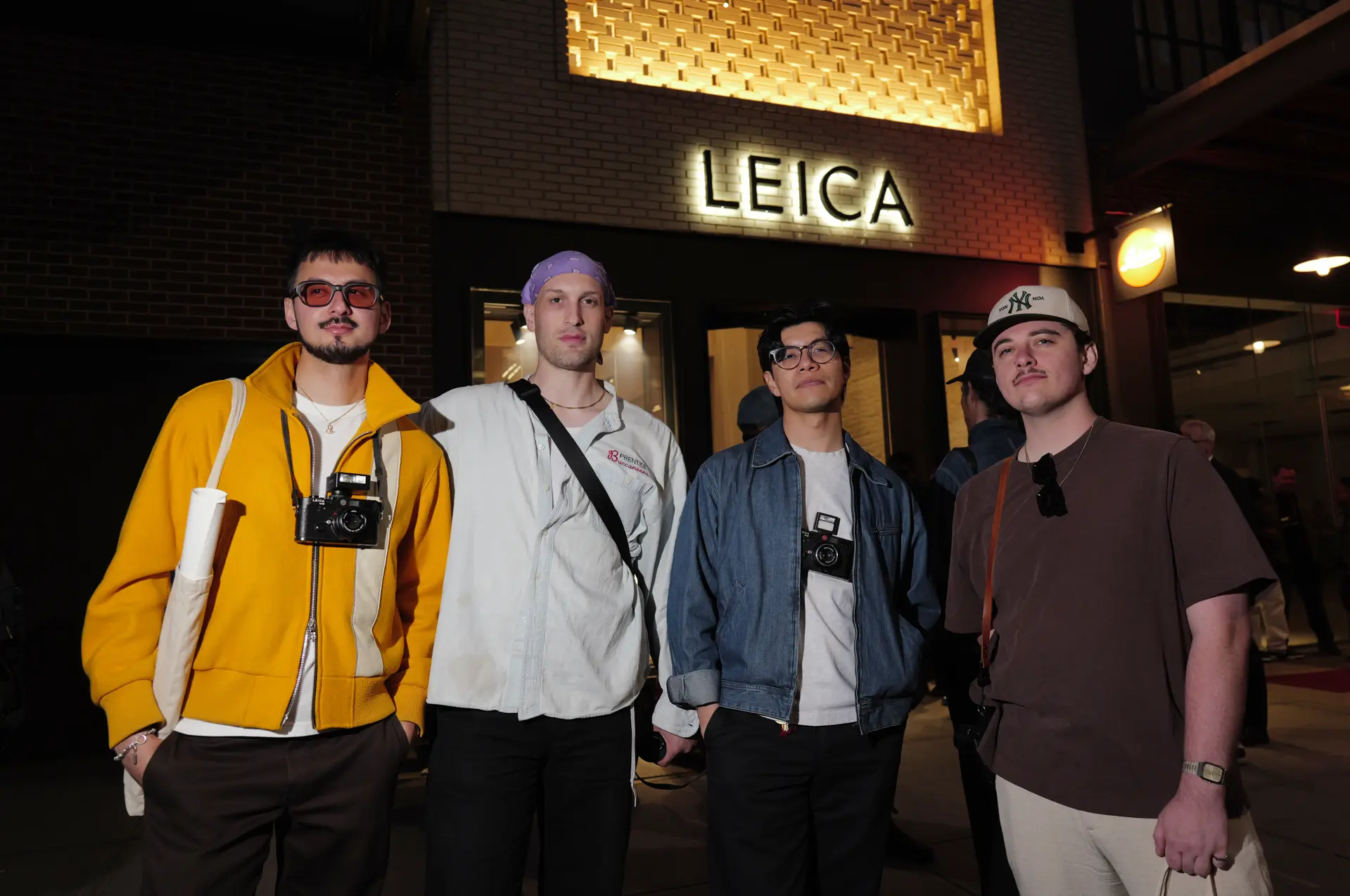 Four trendy boys with leica cameras