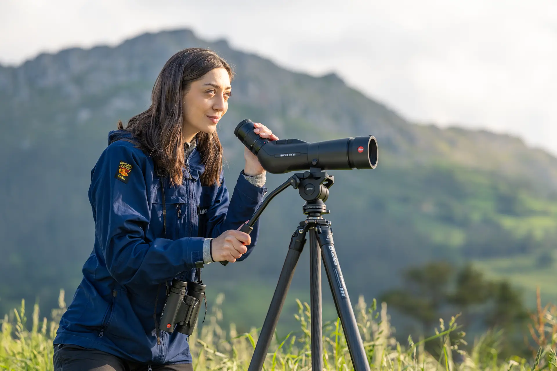 Woman is looking through her Leica Televid HD spotting scope