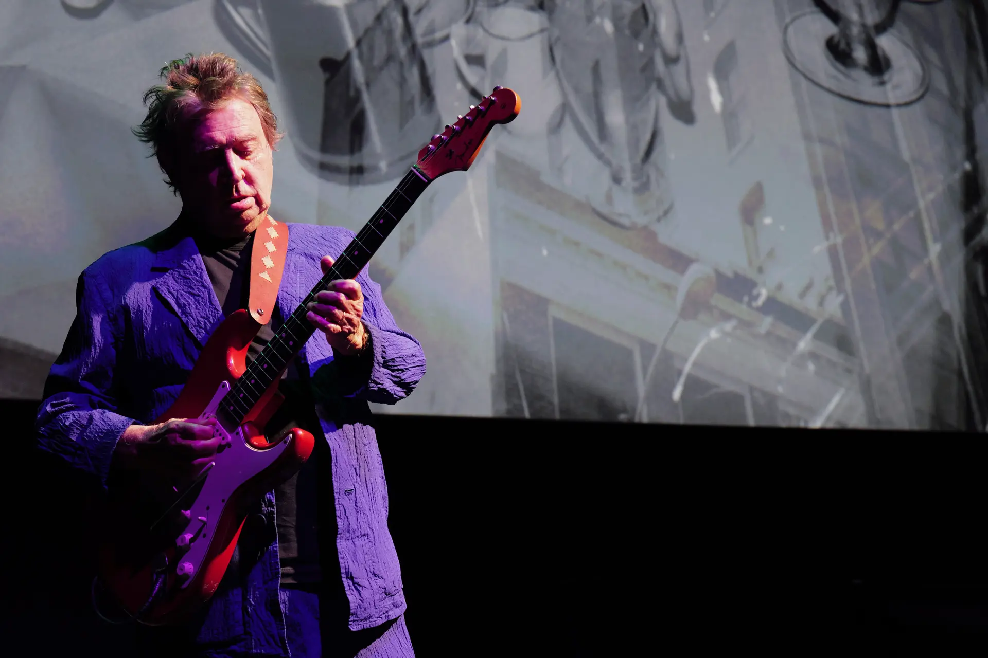 Leica 100 Years Event New York Man with a guitar and violet jacket
