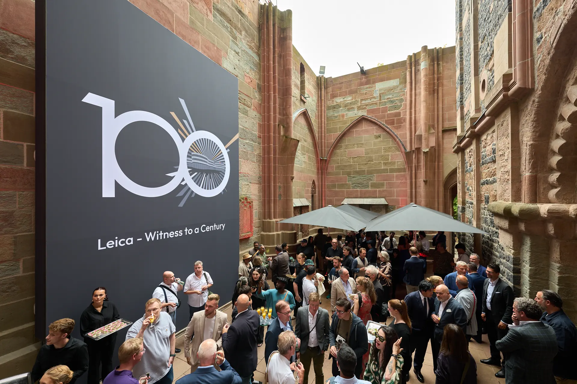 Leica Century Celebration Wetzlar Lots of people in the courtyard of Wetzlar Cathedral at the champagne reception