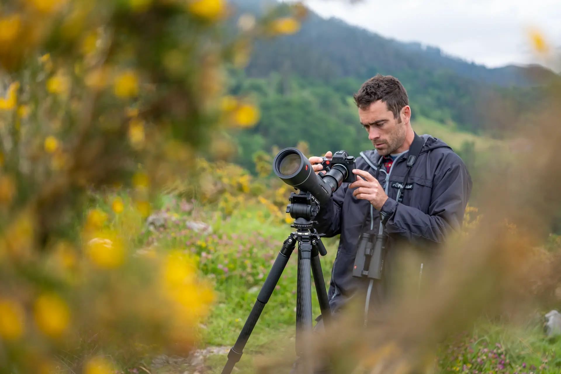 Man is digiscoping with his Leica APO-Televid spotting scope