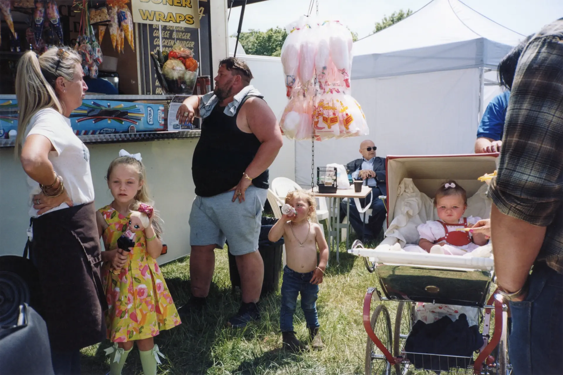 A family standing in front of an imbiss car.