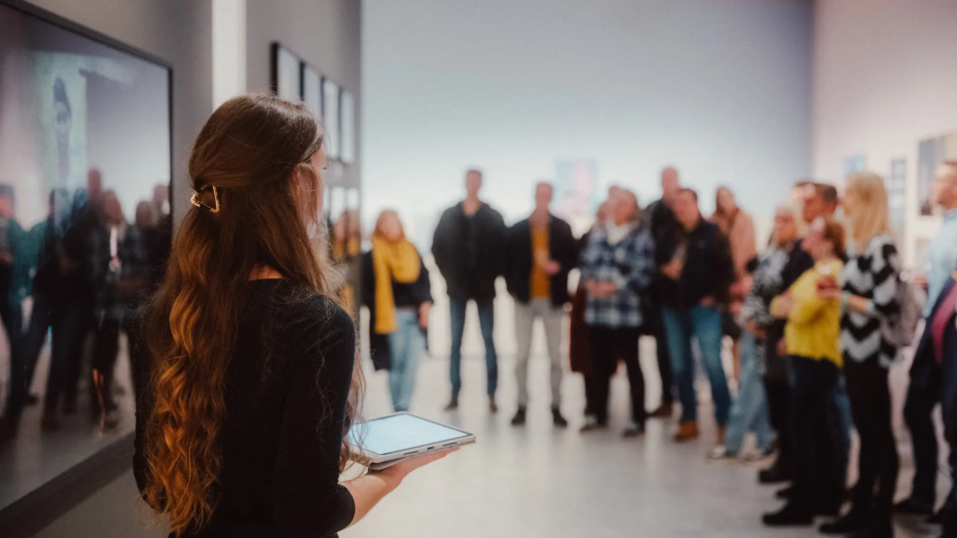 A woman stands in front of a group of people