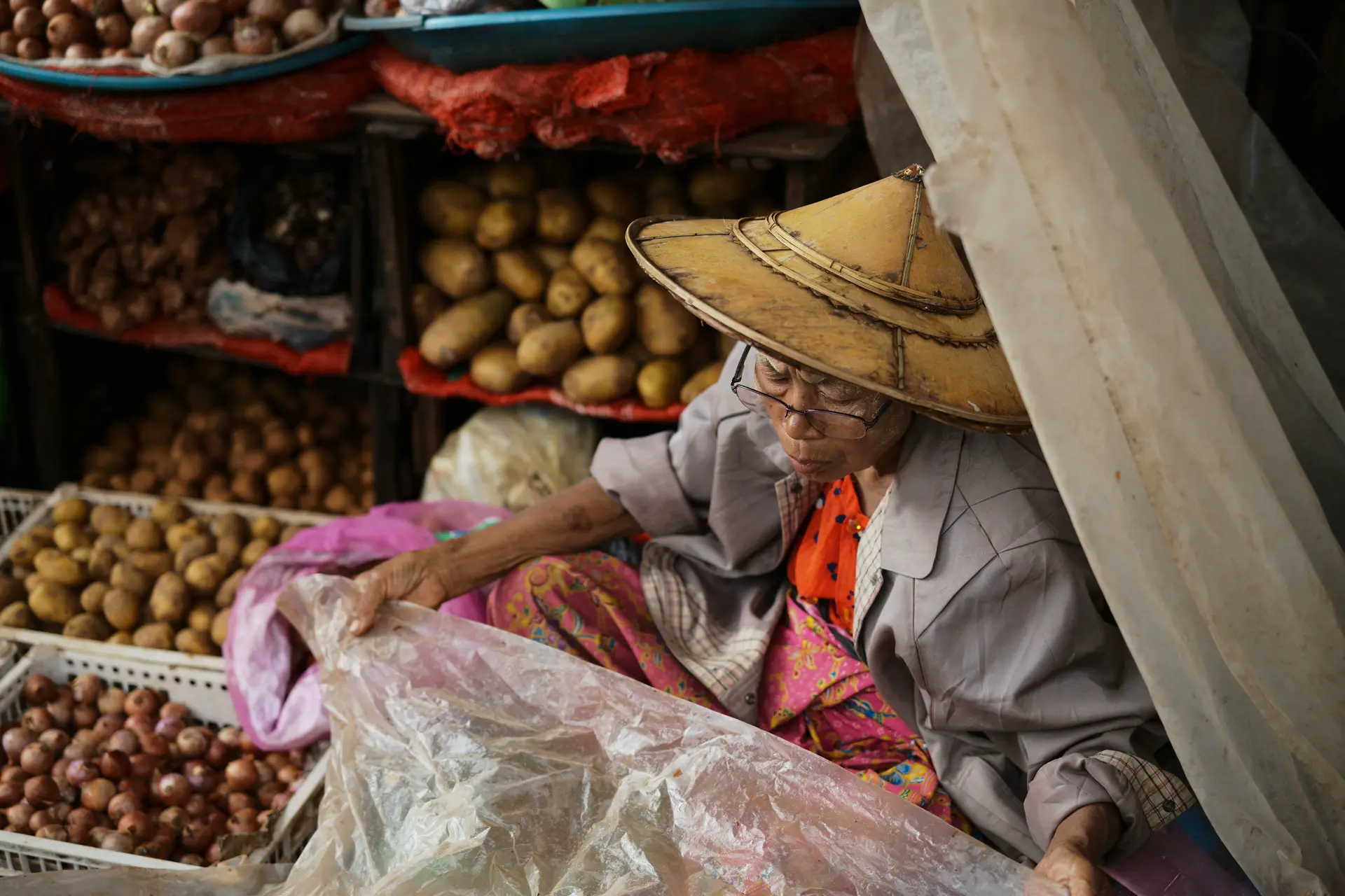 person in a market selling vegetables
