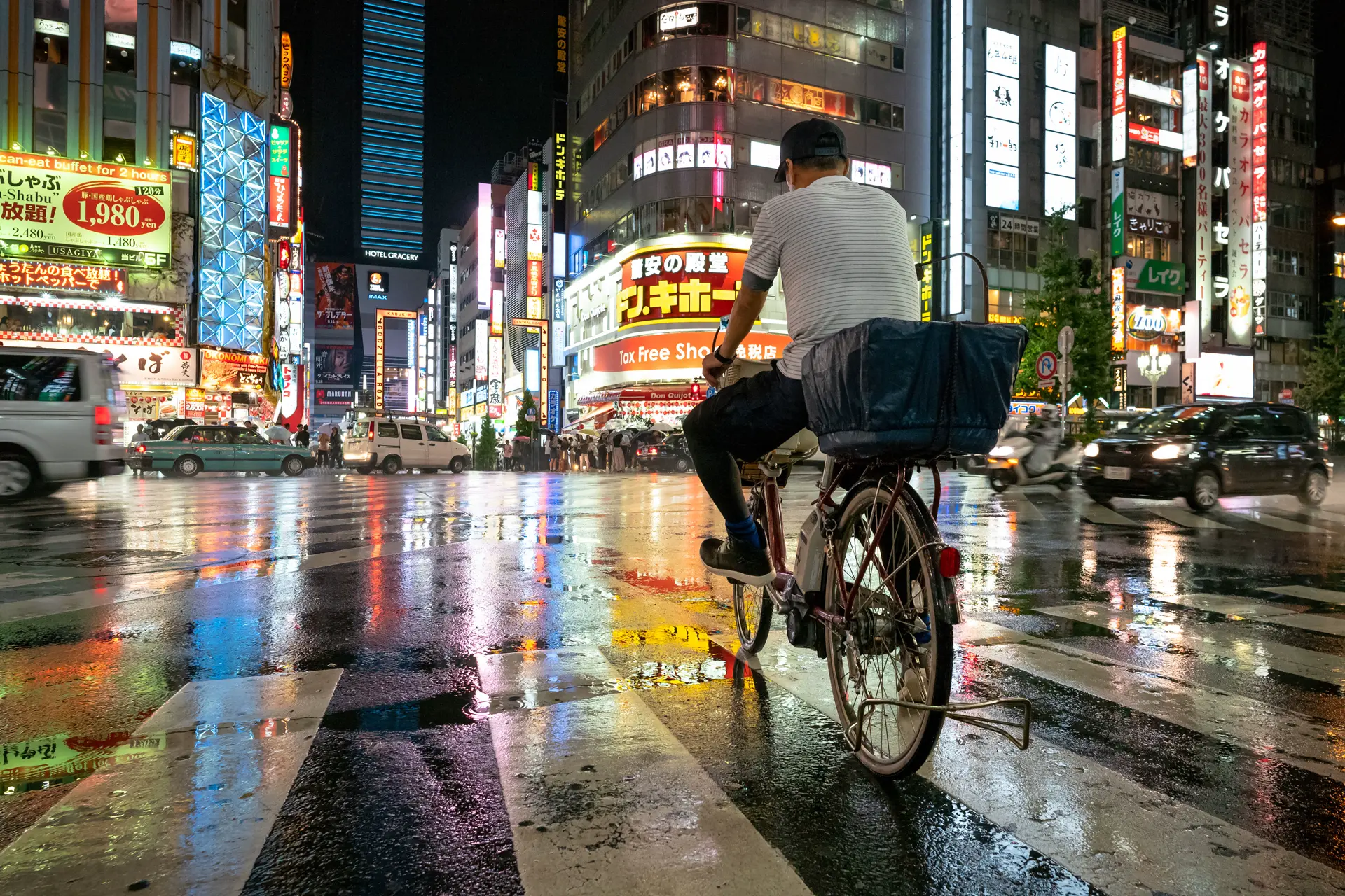 You are riding a bicycle in a large Asian city.