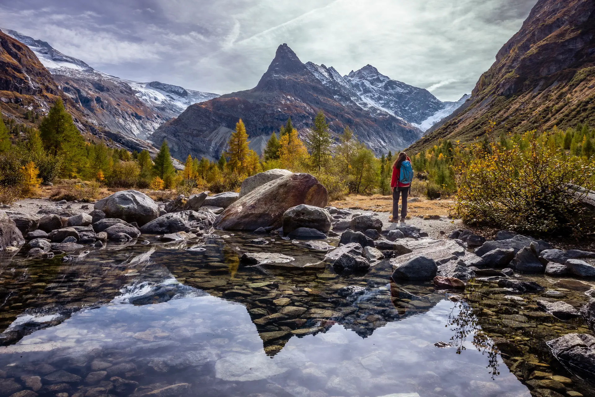 Woman standing on rocks in a wild mountainous area