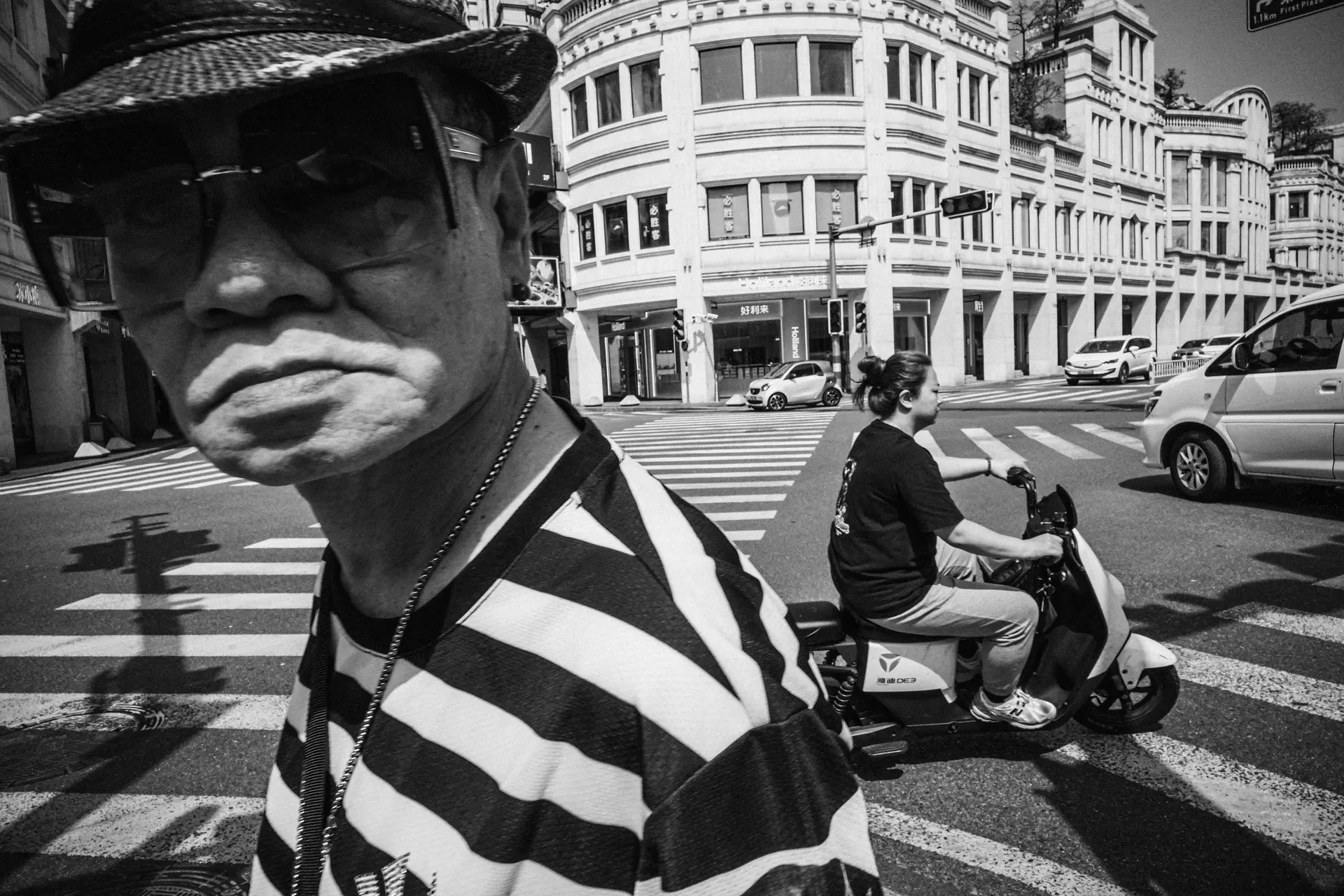 Man wearing a striped shirt at a crosswalk
