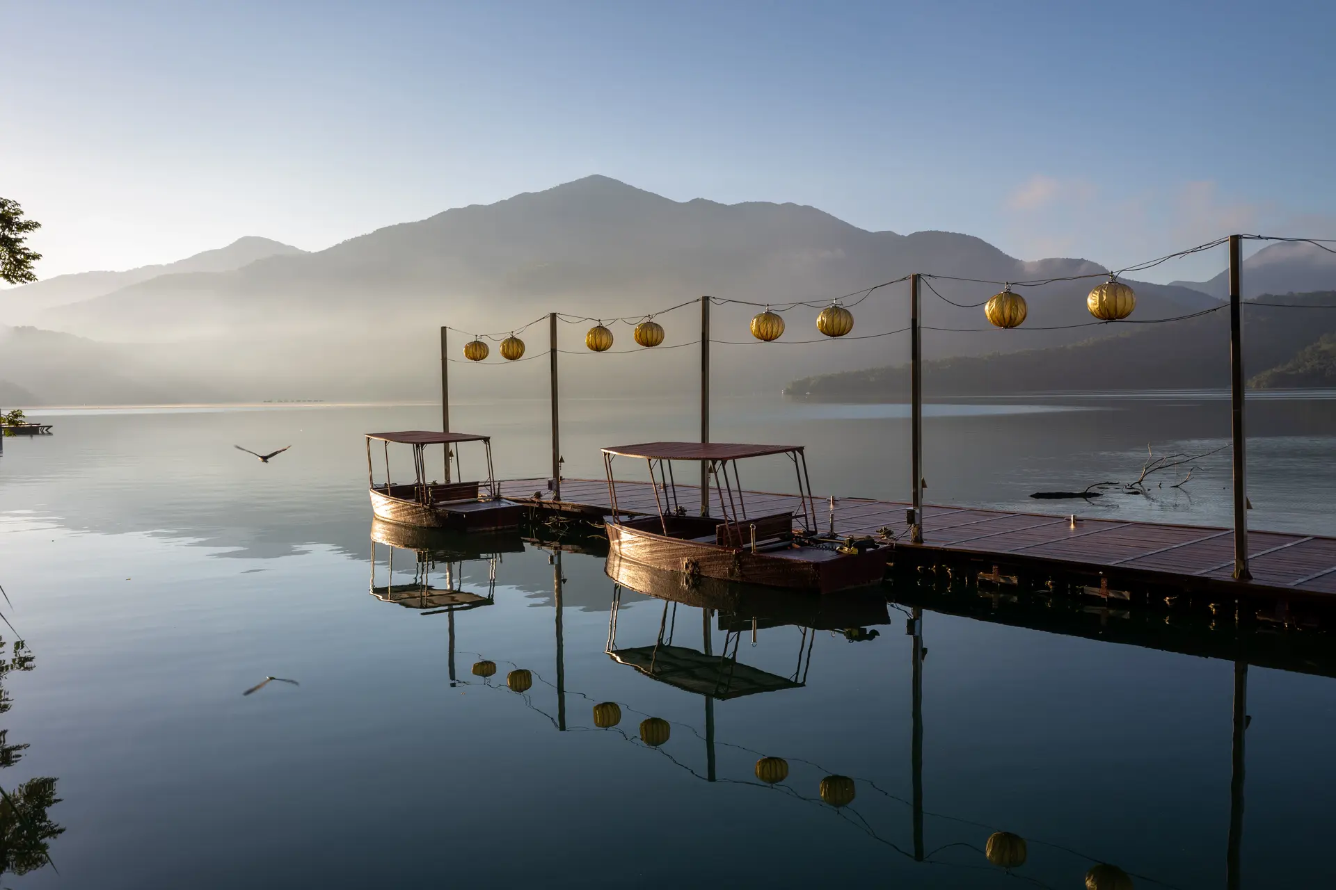 A lake with old boats at a jetty