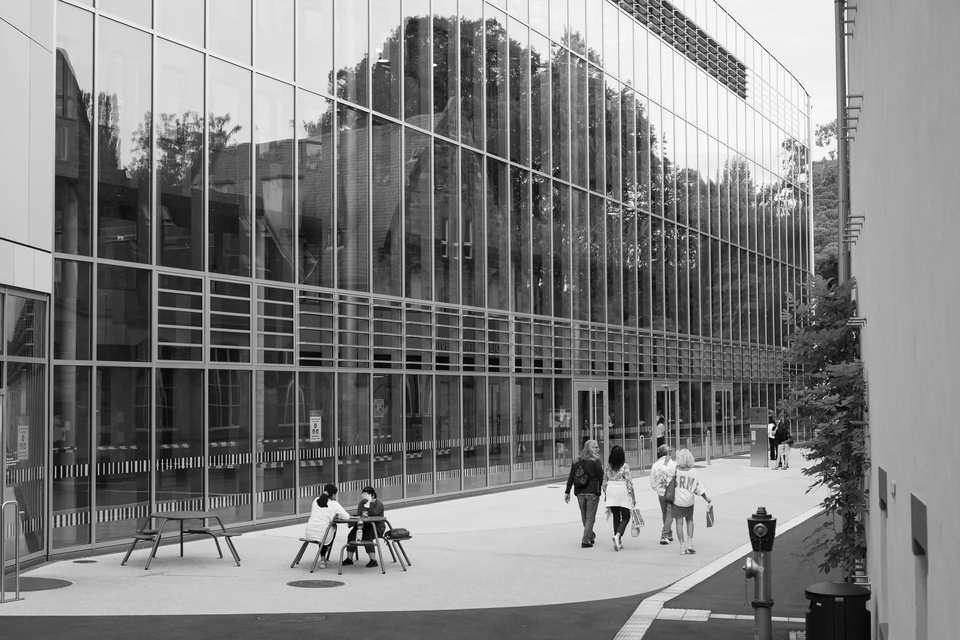 A glass building an people walking