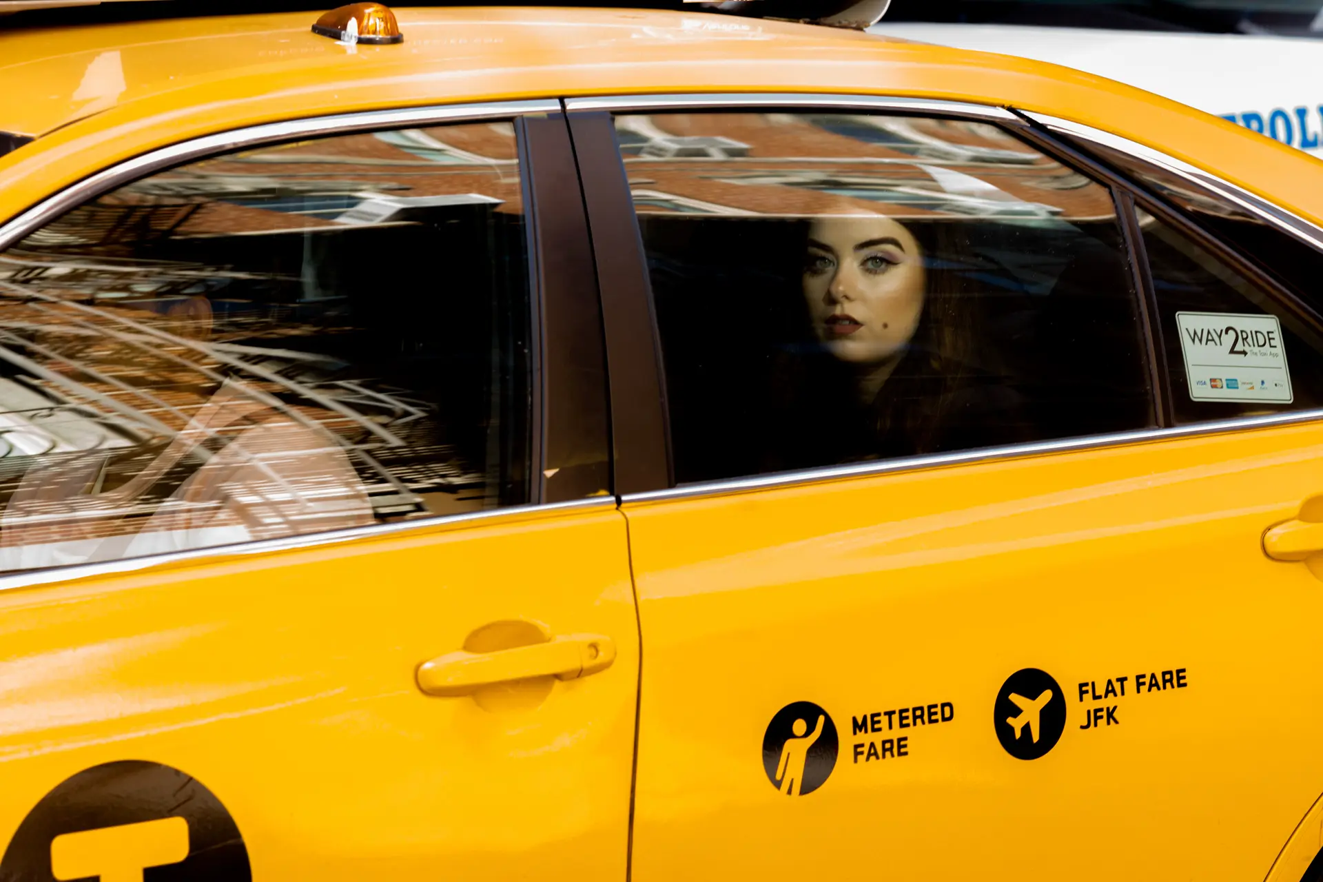 Woman in a taxi looking out the window