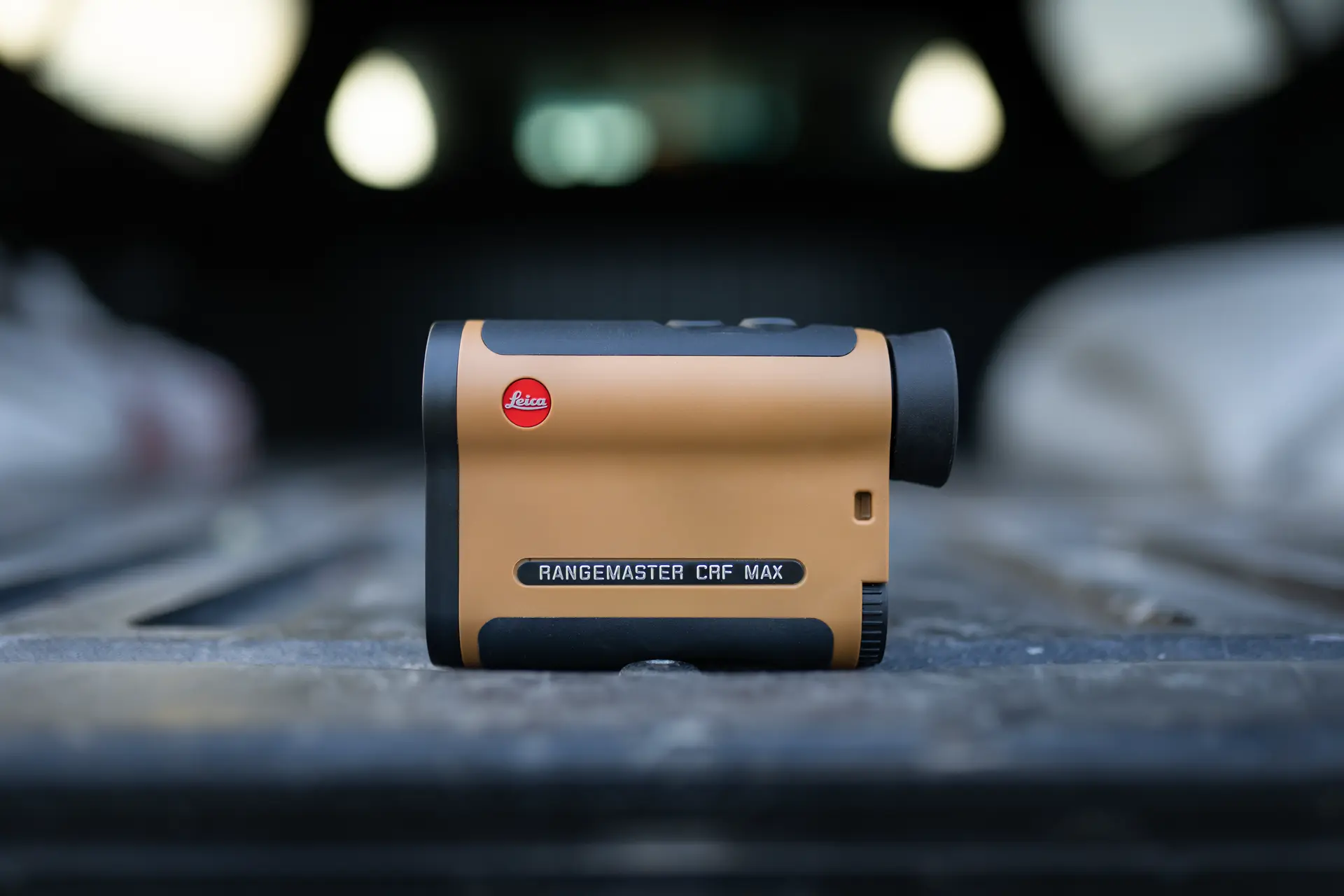 Leica Rangemaster CRF MAX is lying on a truck
