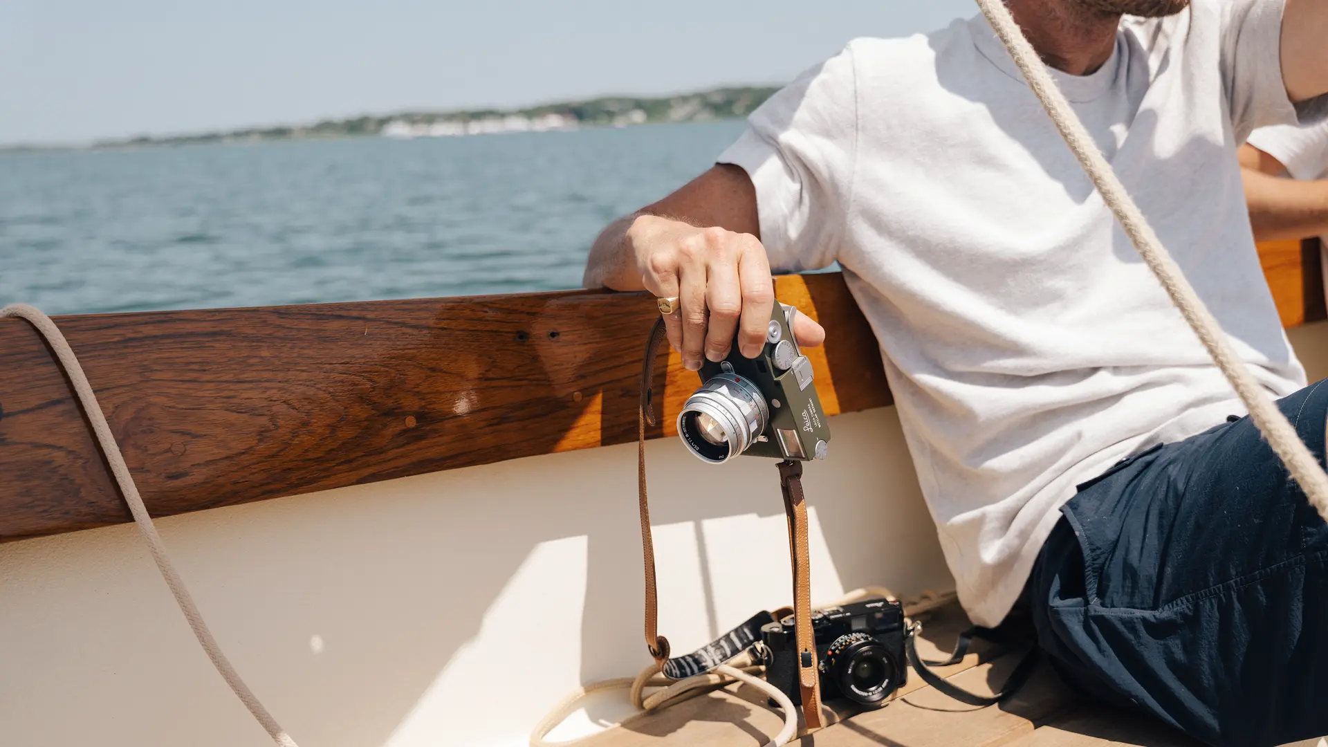 Riley on a boat with his Leica in his hand