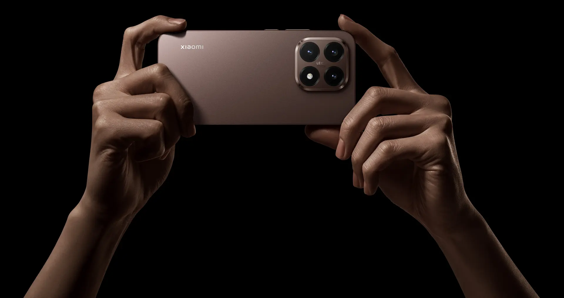 Two hands holding the Xiamoi 15T rose gold.