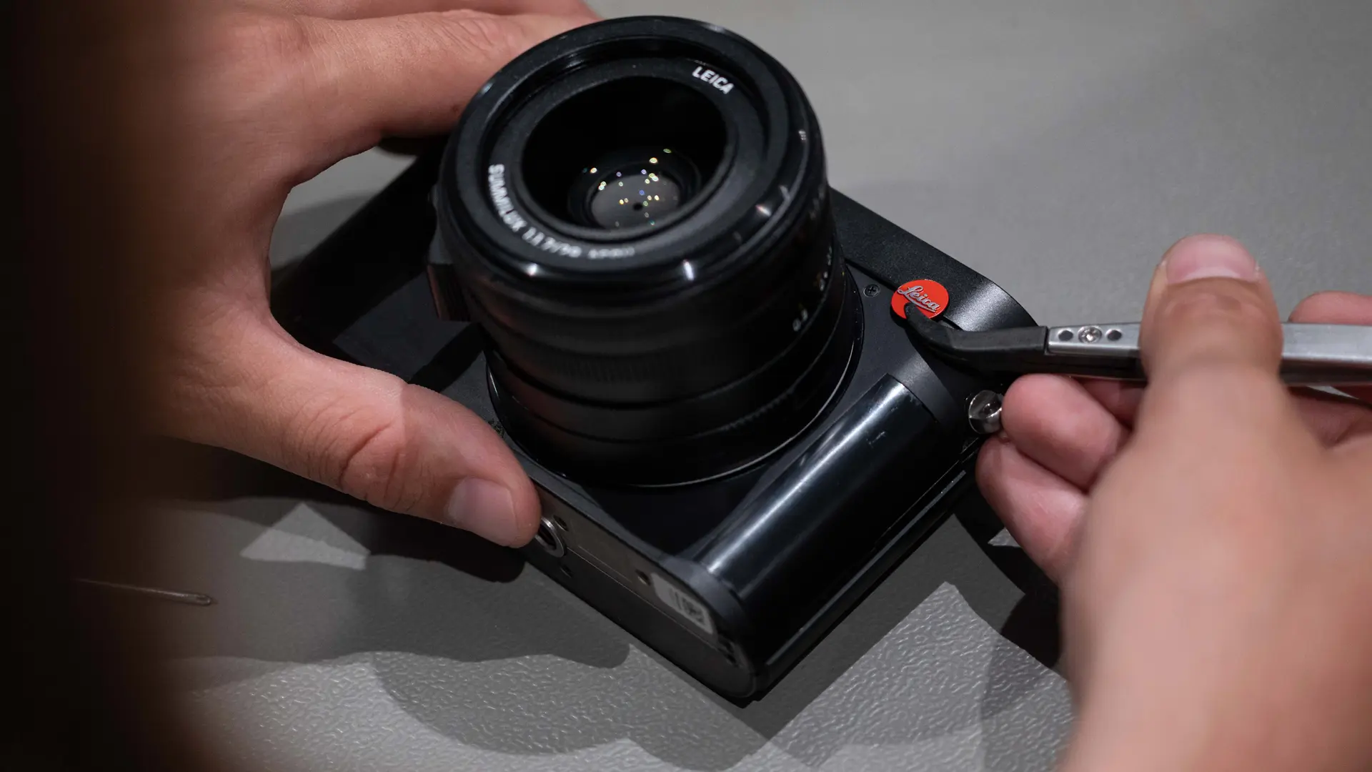 Colour photo of Leica Q camera being serviced