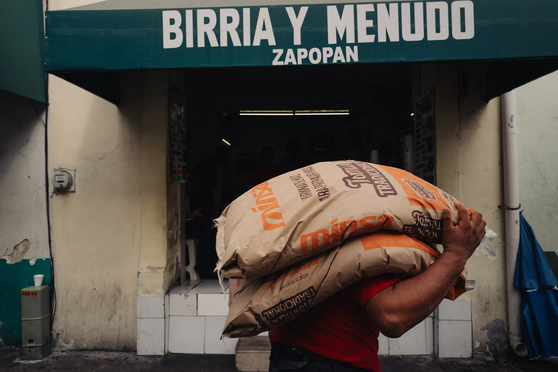 A man carrying a sack of corn