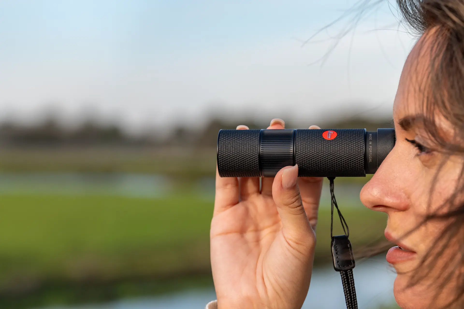 Woman is looking through her Leica Monovid