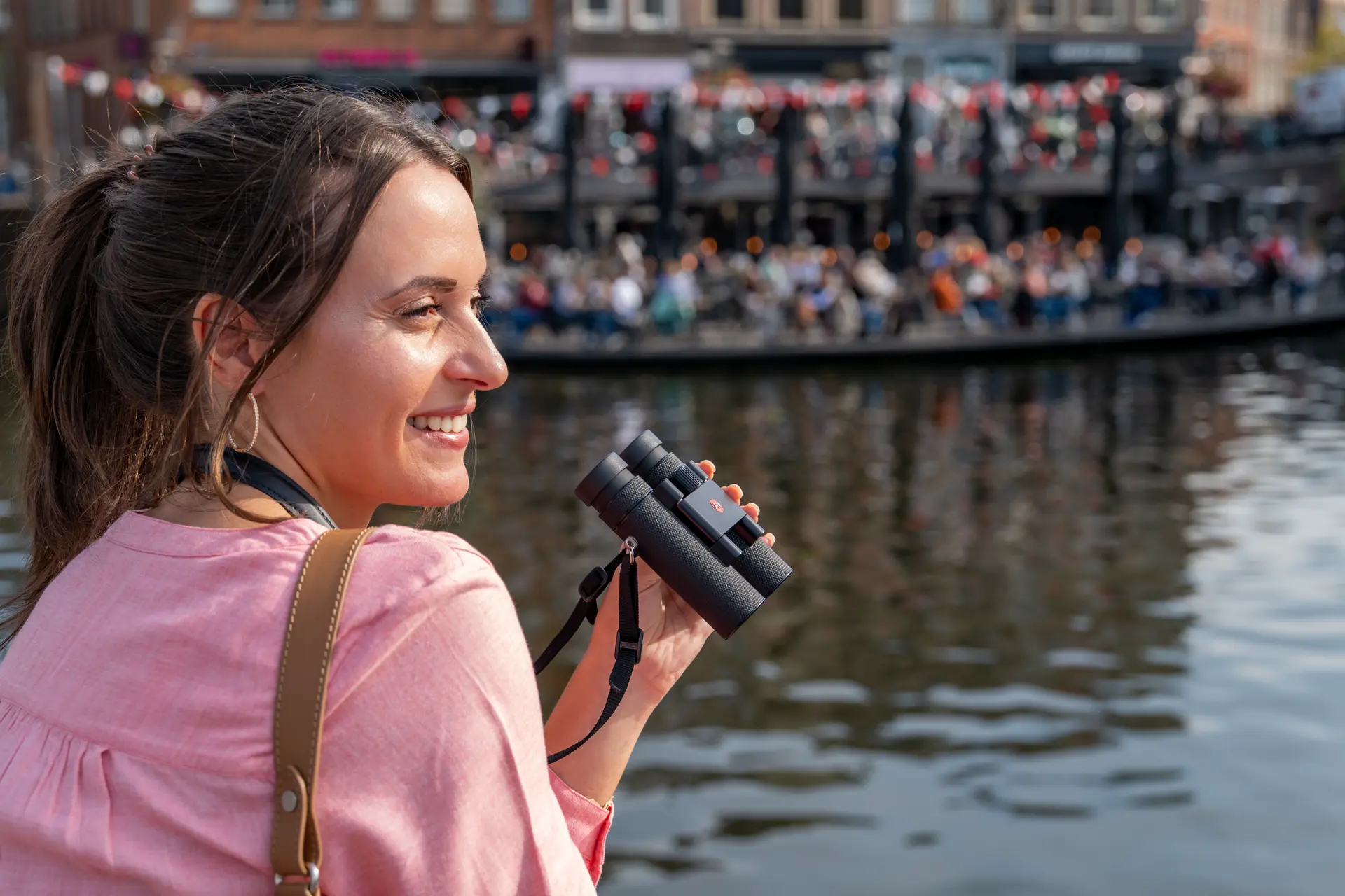 Woman holding her Leica Noctivid Compact