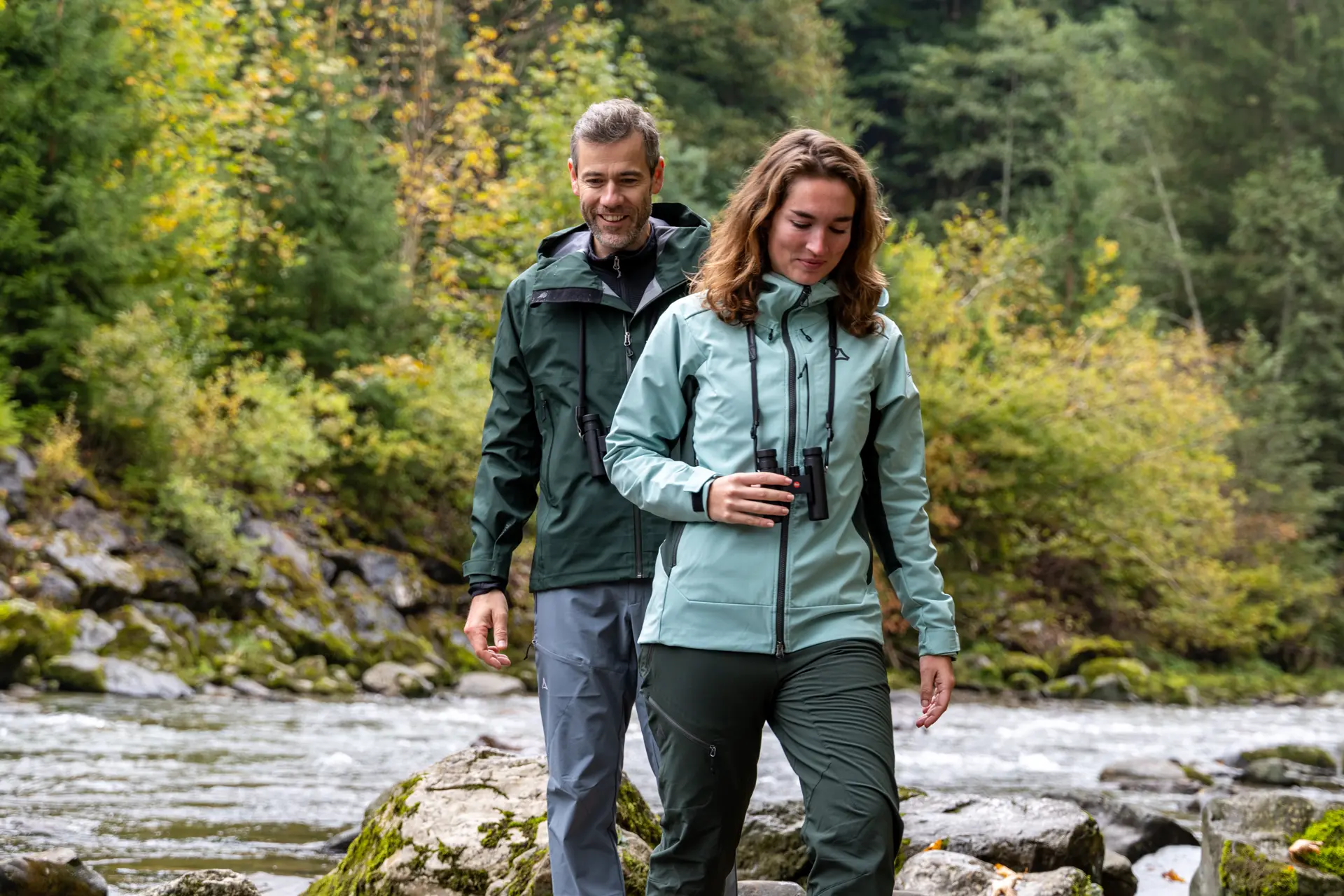 Two hikers walking through a riverbed