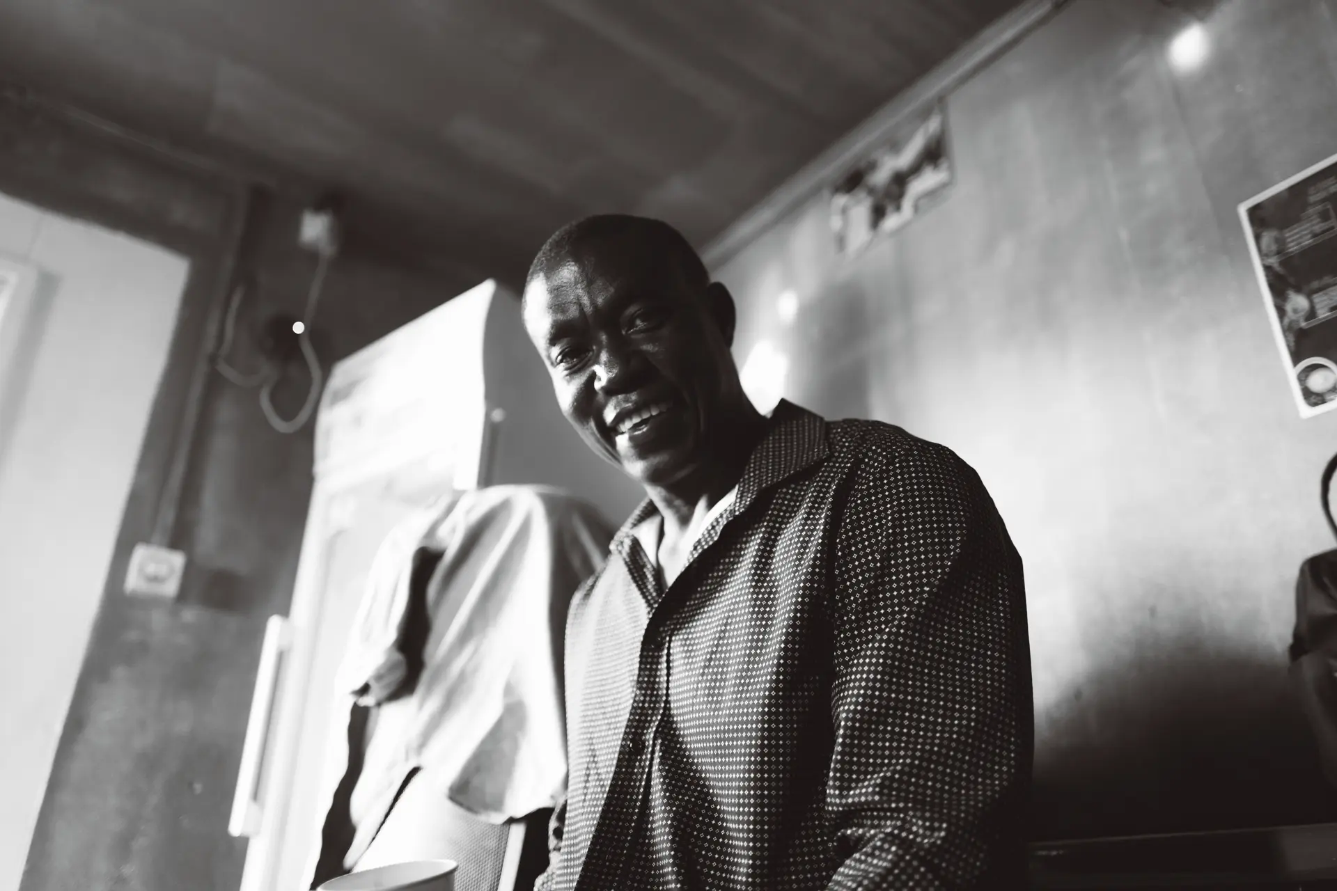 Black and white photograph of man smiling for the camera