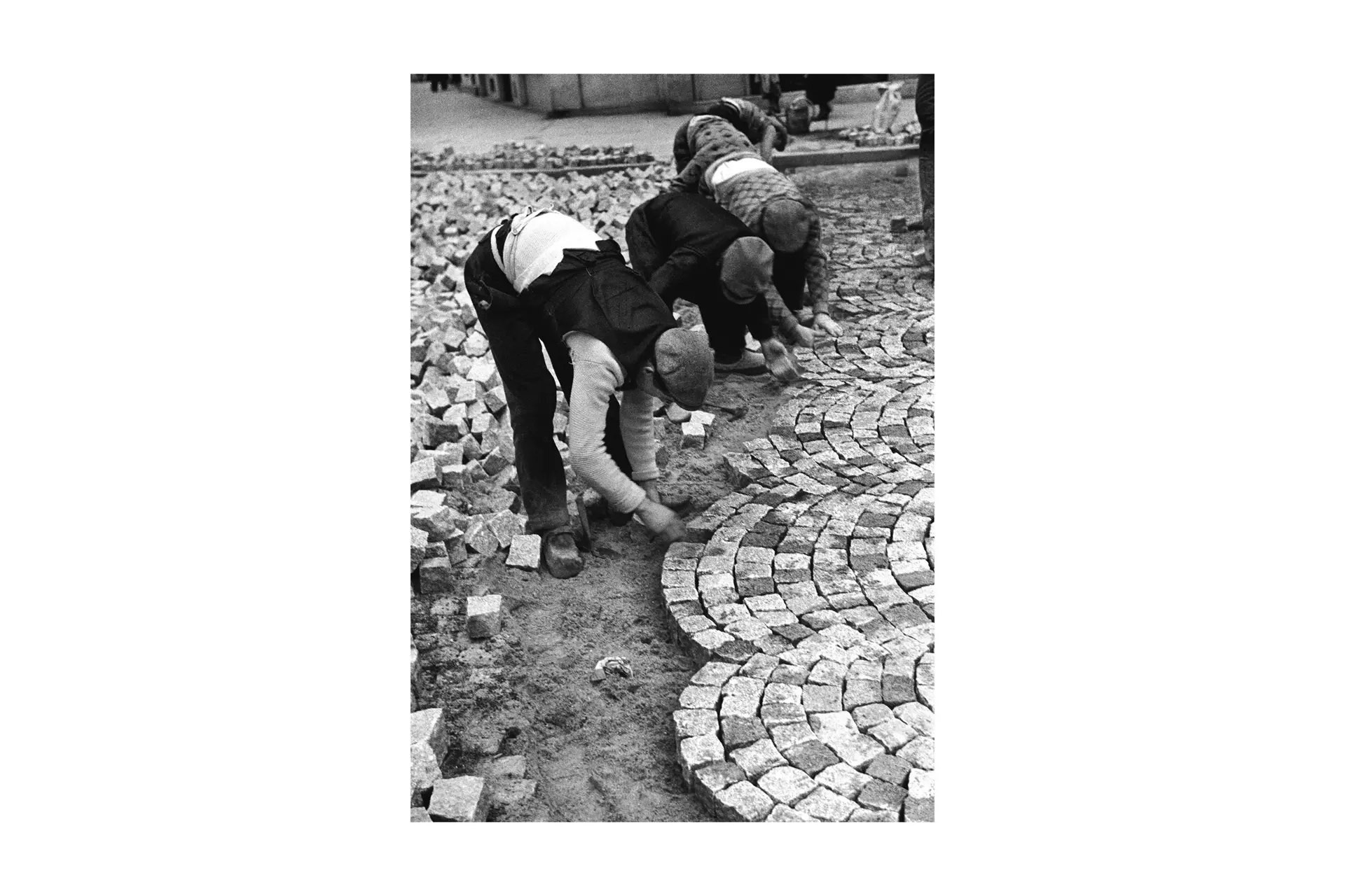 Men building a street out of Cobblestones
