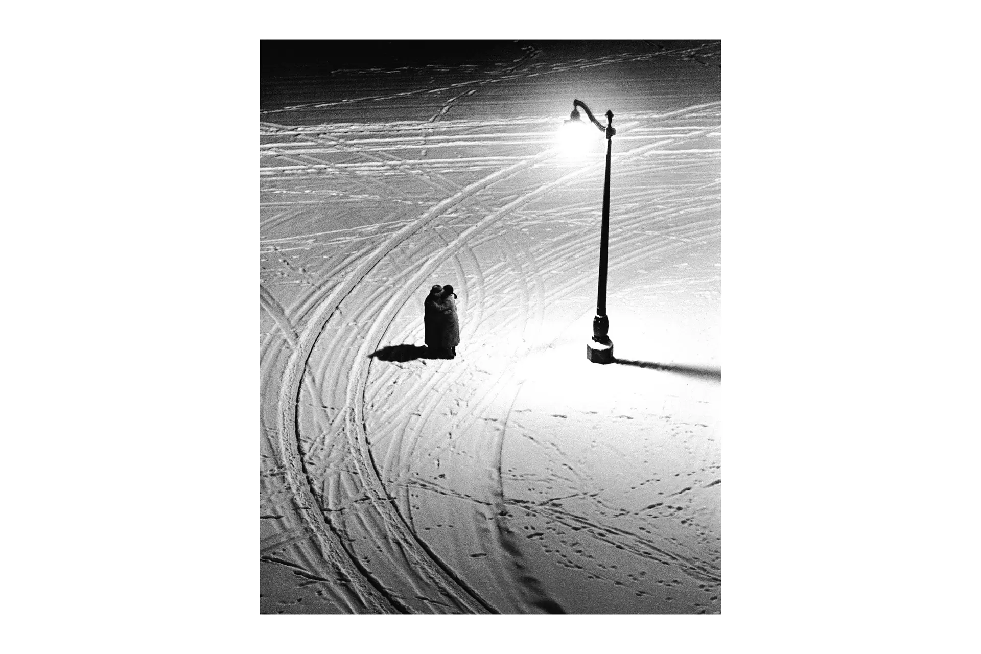 Two Person in the snow under a streetlight
