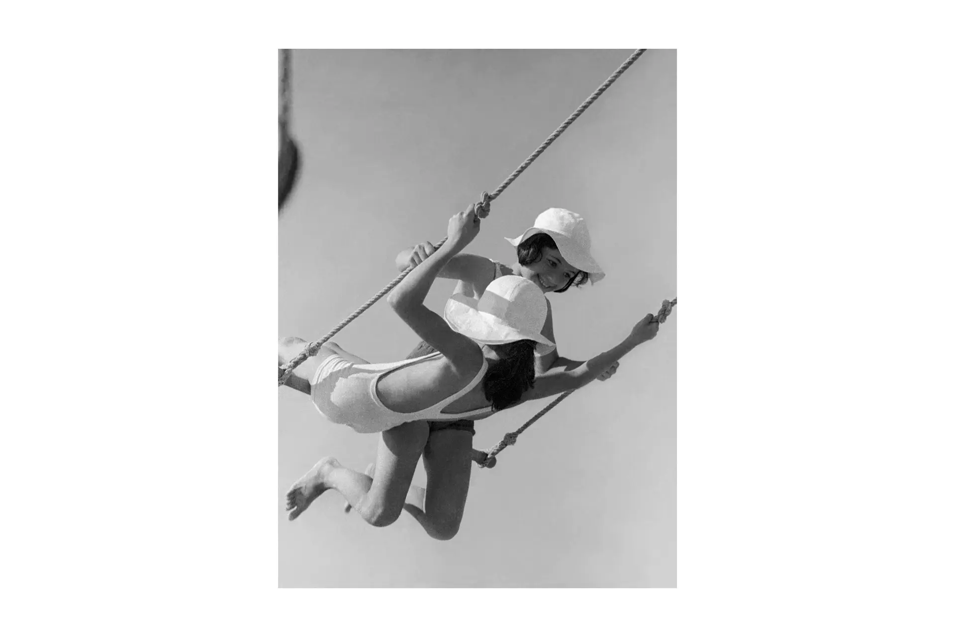 Two girls on a swing