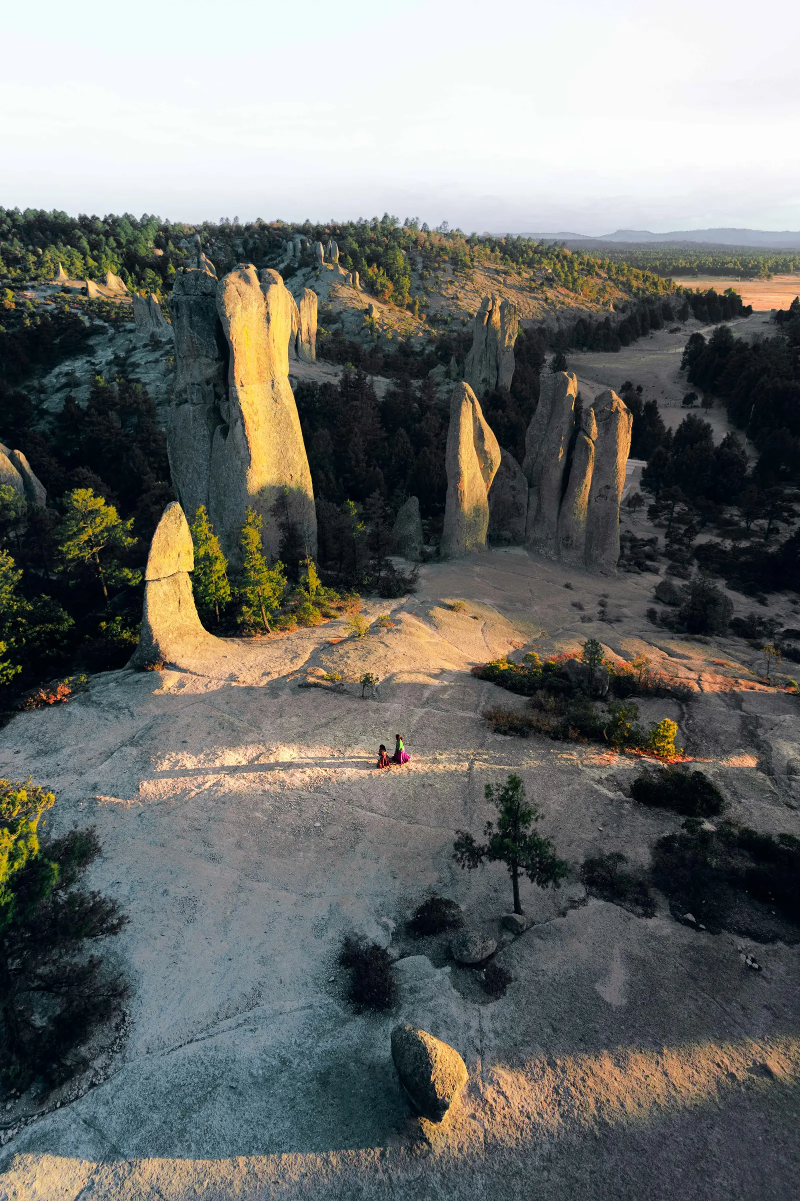 People sitting between mountains