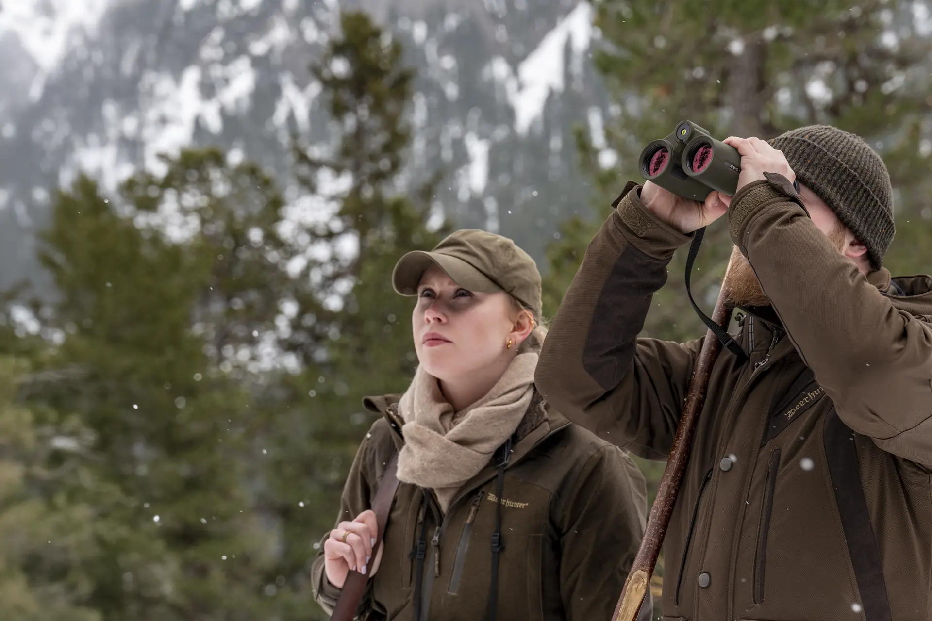 Two hunters in the mountains looking through their Leica Geovid Pro