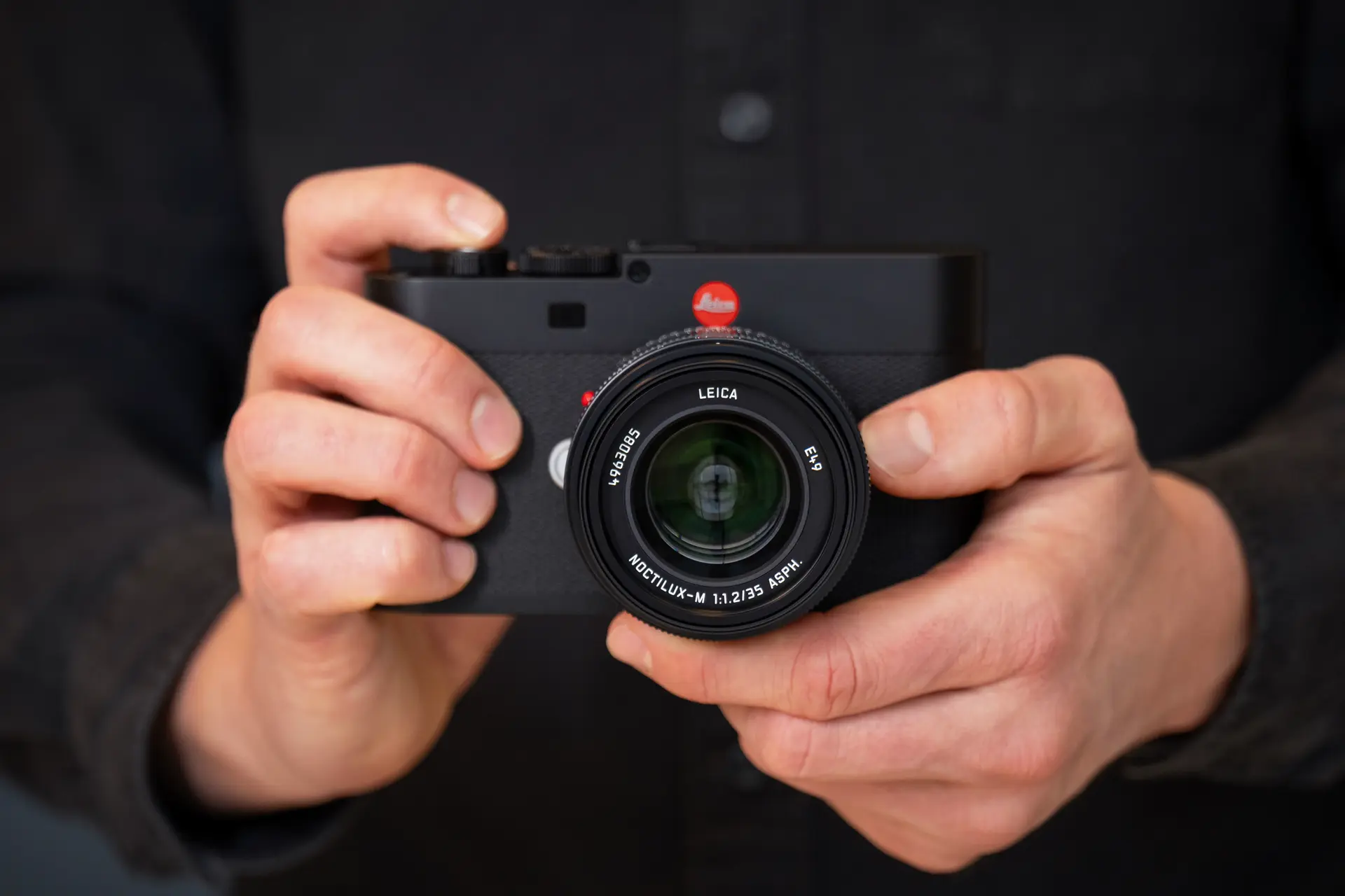 A man is holding the Leica M EV1