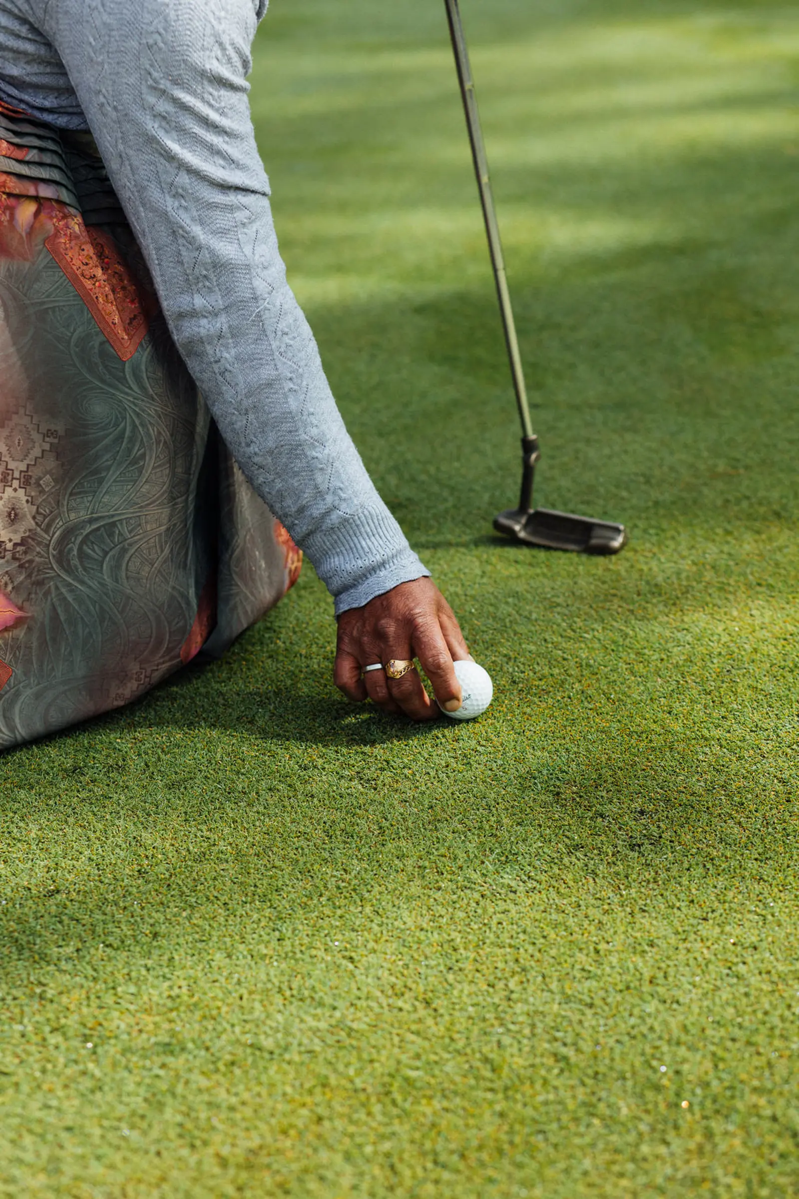 woman holding golf ball.