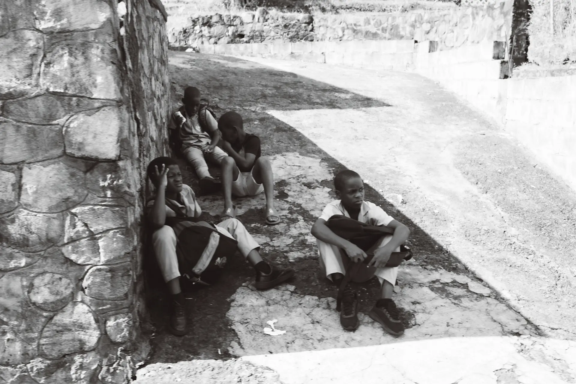 Four kids waiting in the shade
