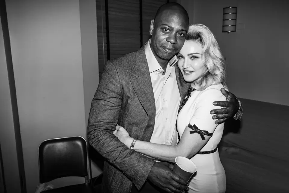 Dave Chappelle and Madonna in an embrace
