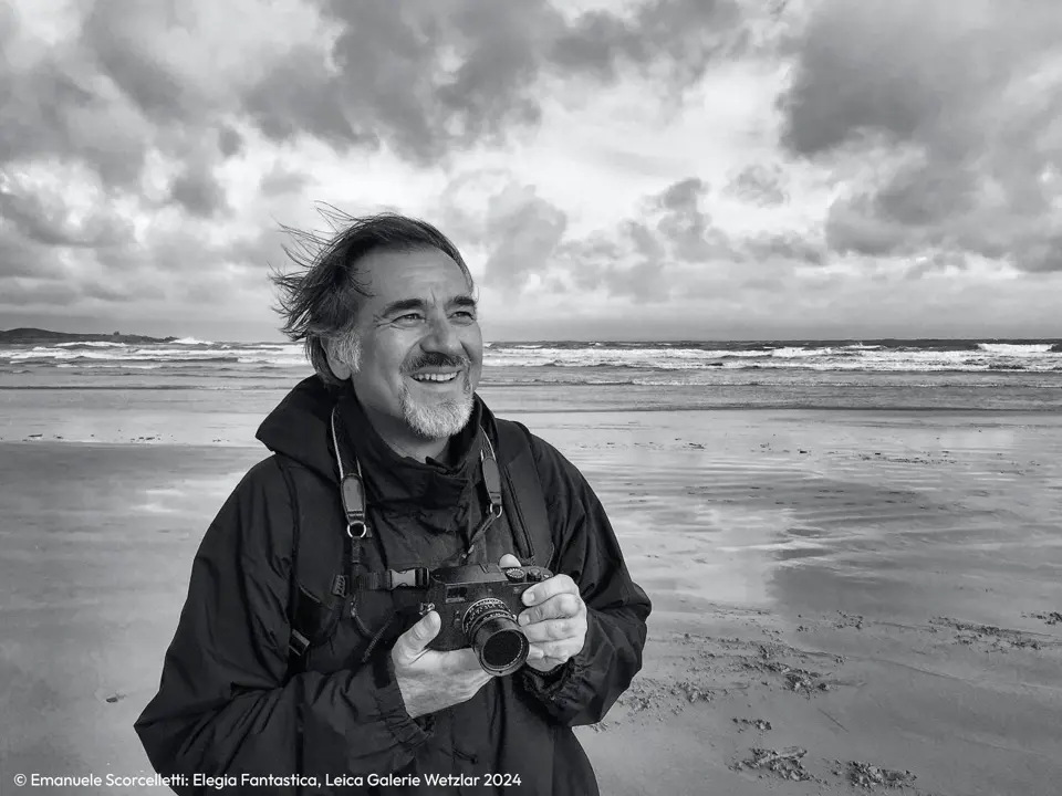 Man with a Leica camera in his hand by the sea