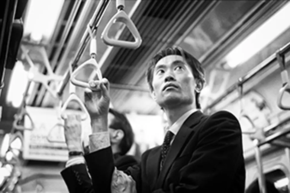 Shot by Andy Summers showing a man standing in a train.